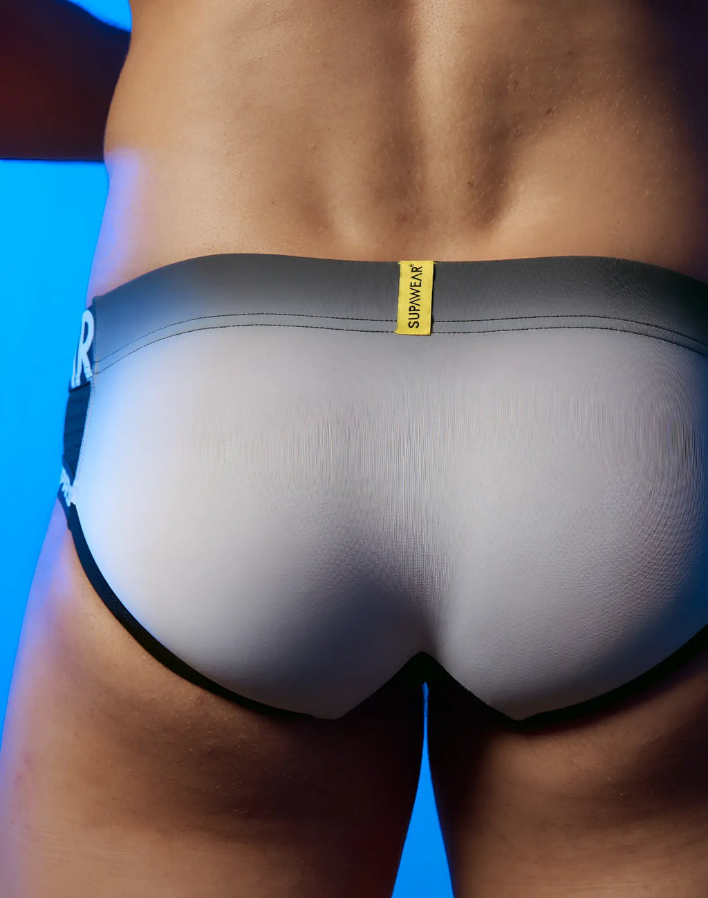 Gray and black supawear spr performance gradient briefs with yellow brand tag for activewear use
