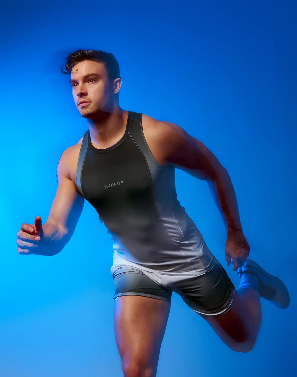 Black and gray SUPAWEAR SPR performance singlet with sunwear branding designed for athletic use