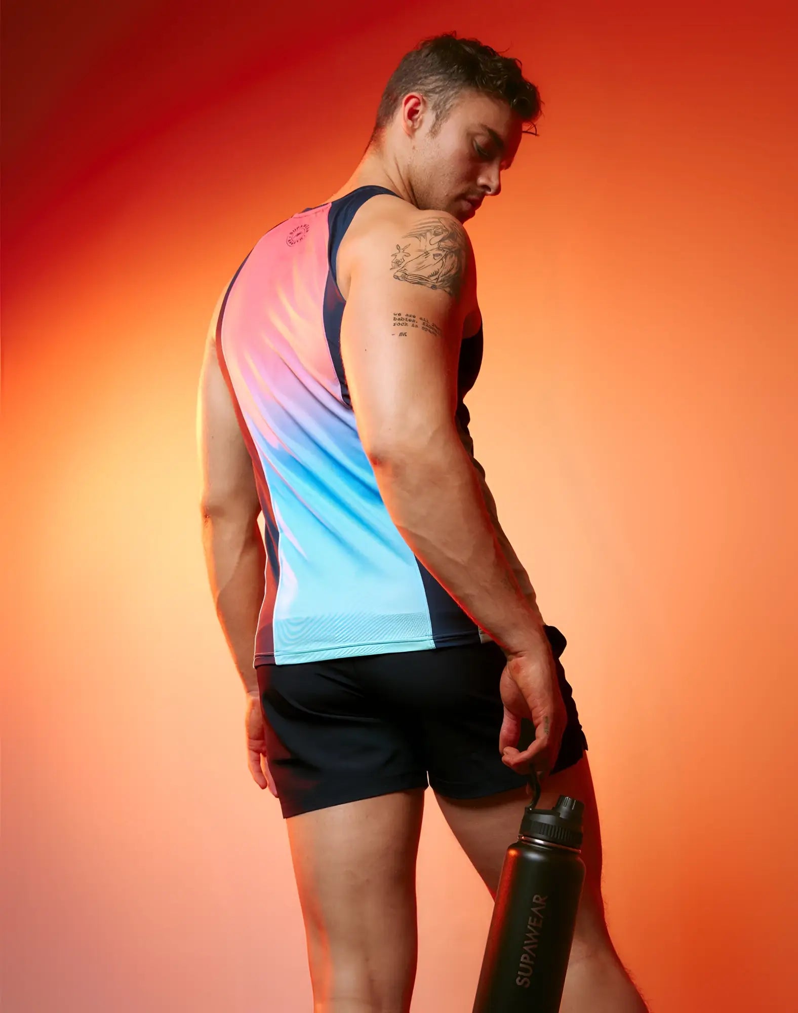 Black supawear water bottle with sleek matte finish and black screw-on cap shown with supawear spr performance singlet rainbow