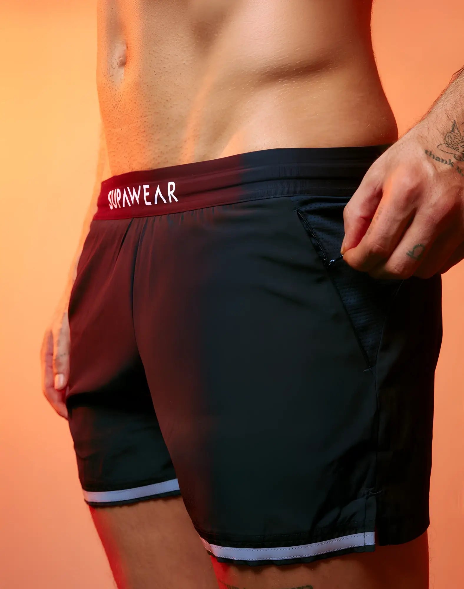 Black supawear spr performance athletic shorts with maroon waistband and gray hem trim for active wear