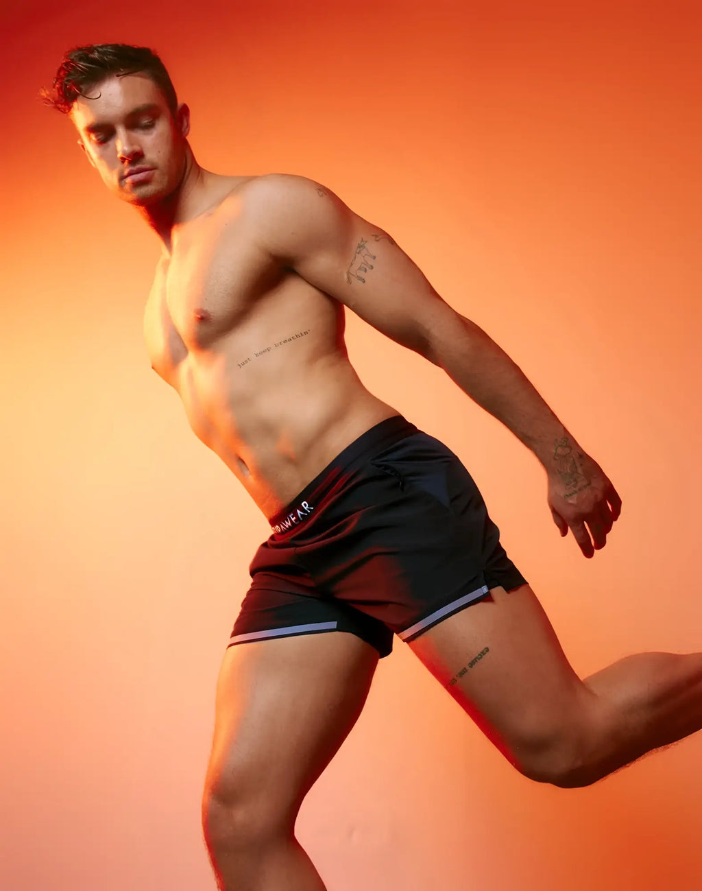 Black supawear spr performance athletic shorts with red and white trim and primewear logo on the waistband