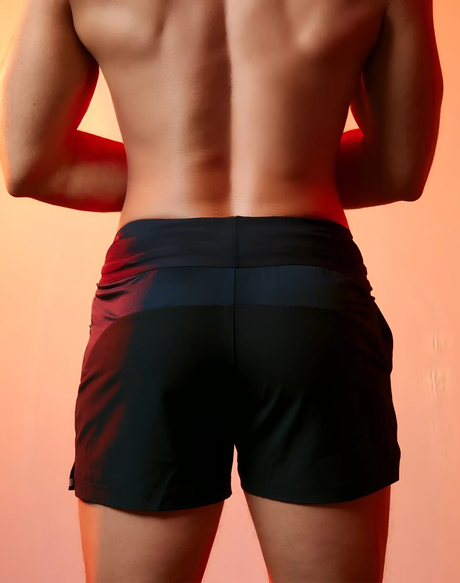 SupaWEAR SPR performance black athletic shorts with subtle red gradient side panels for enhanced comfort and style
