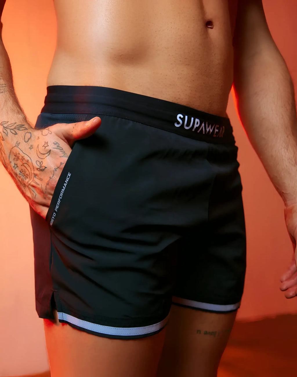 Black supawear spr performance athletic shorts with white trim and branding designed for active wear