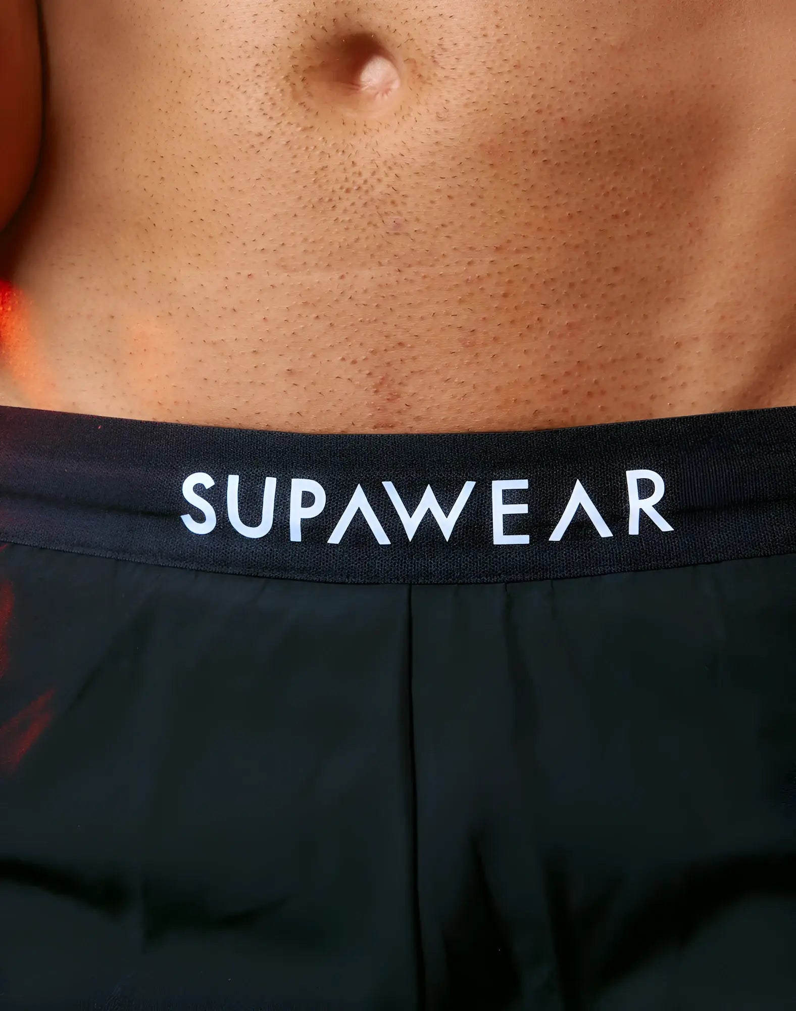 Black supawear spr performance shorts featuring white lettering on the waistband for activewear use