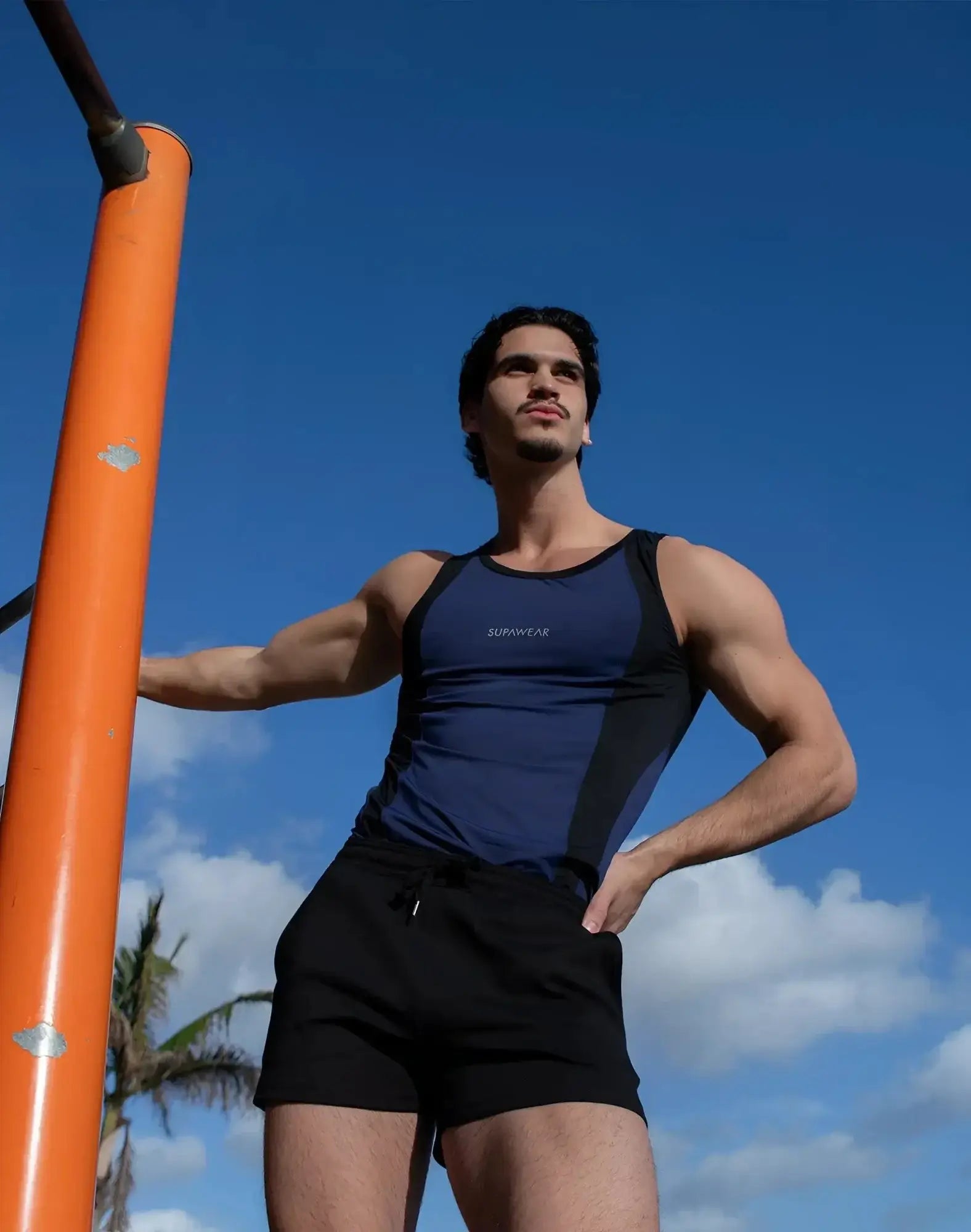 Navy blue and black SUPAWEAR SPR performance singlet with supreme branding on the chest for athletic use