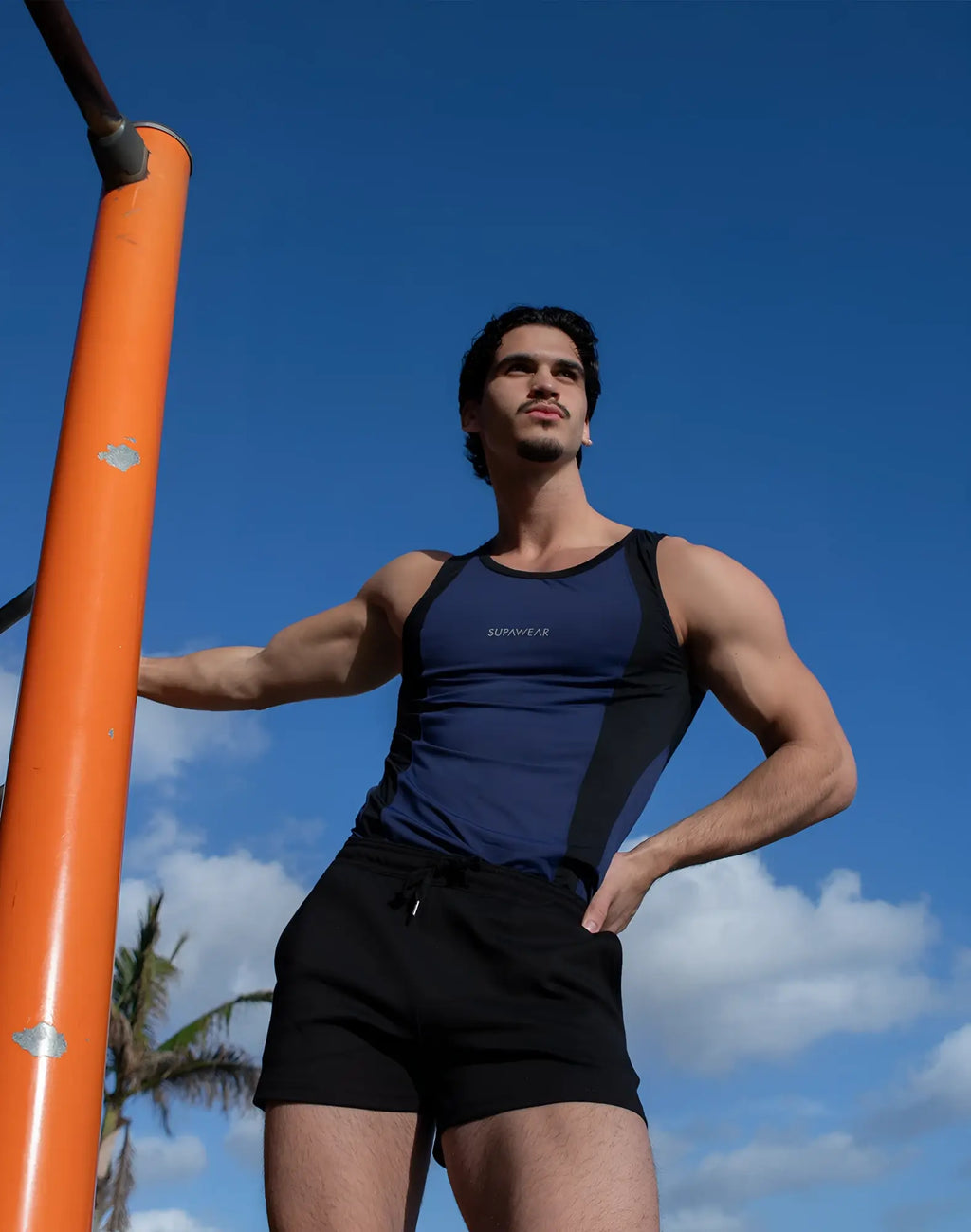 Navy blue and black SUPAWEAR SPR performance singlet with supreme branding on the chest for athletic use