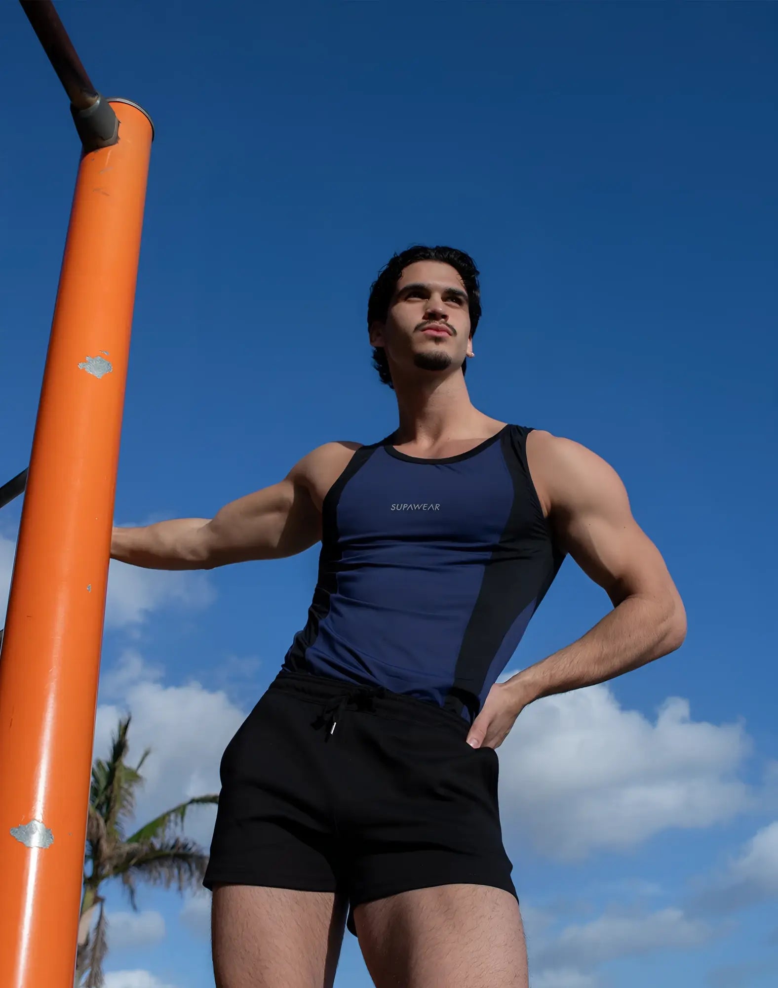 Navy blue and black SUPAWEAR SPR performance singlet with supreme branding on the chest for athletic use