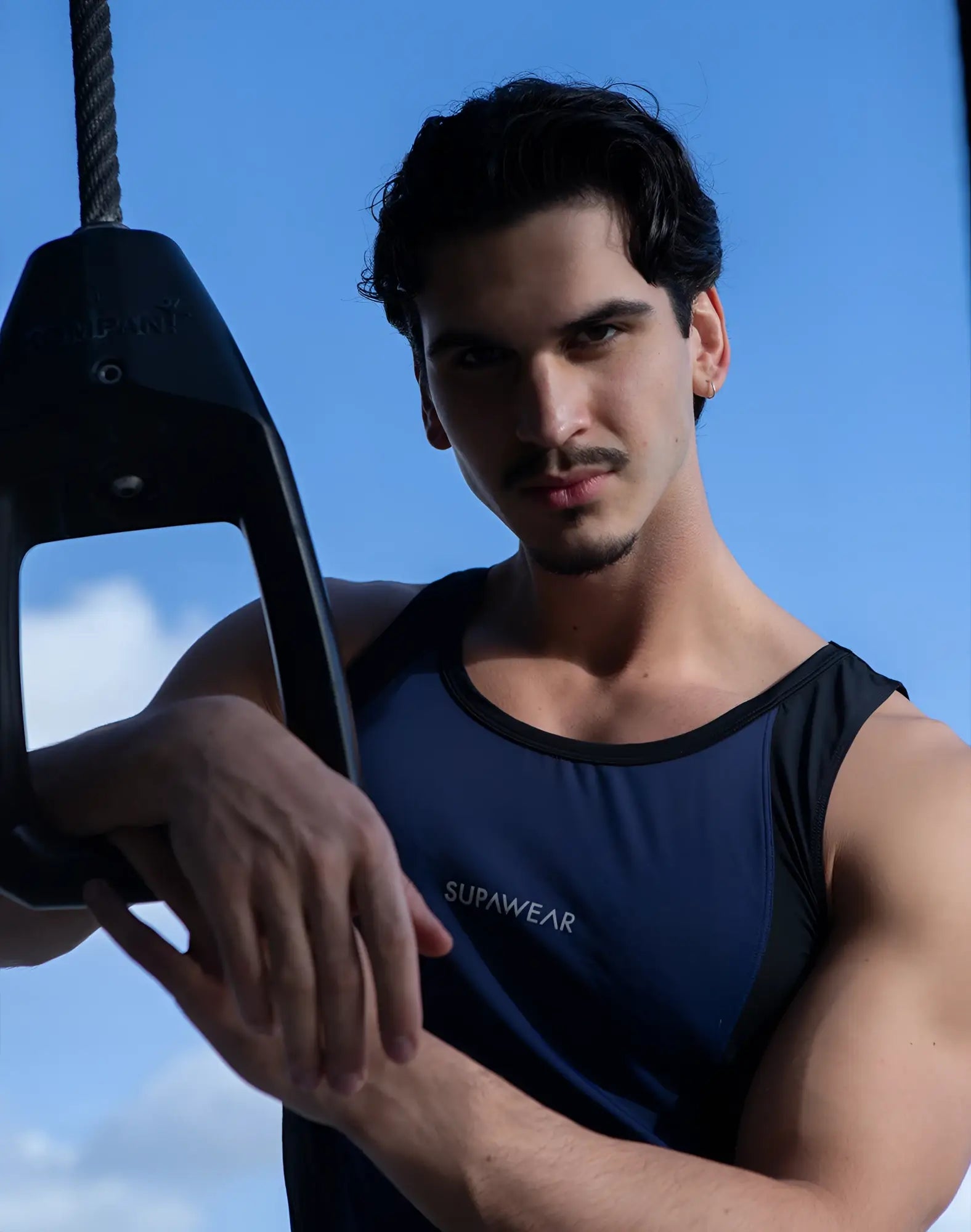 Navy blue supawear performance singlet with black trim and subtle logo on the chest for activewear use