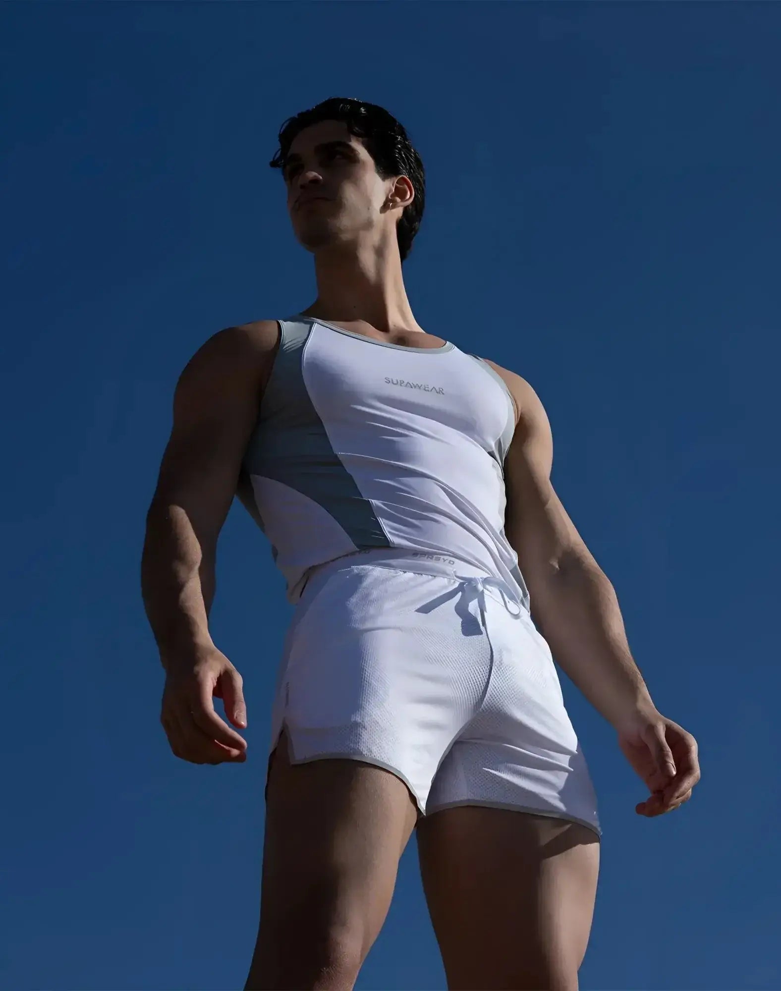 White and gray SUPAWEAR SPR Performance athletic tank top with subtle chest logo designed for active wear