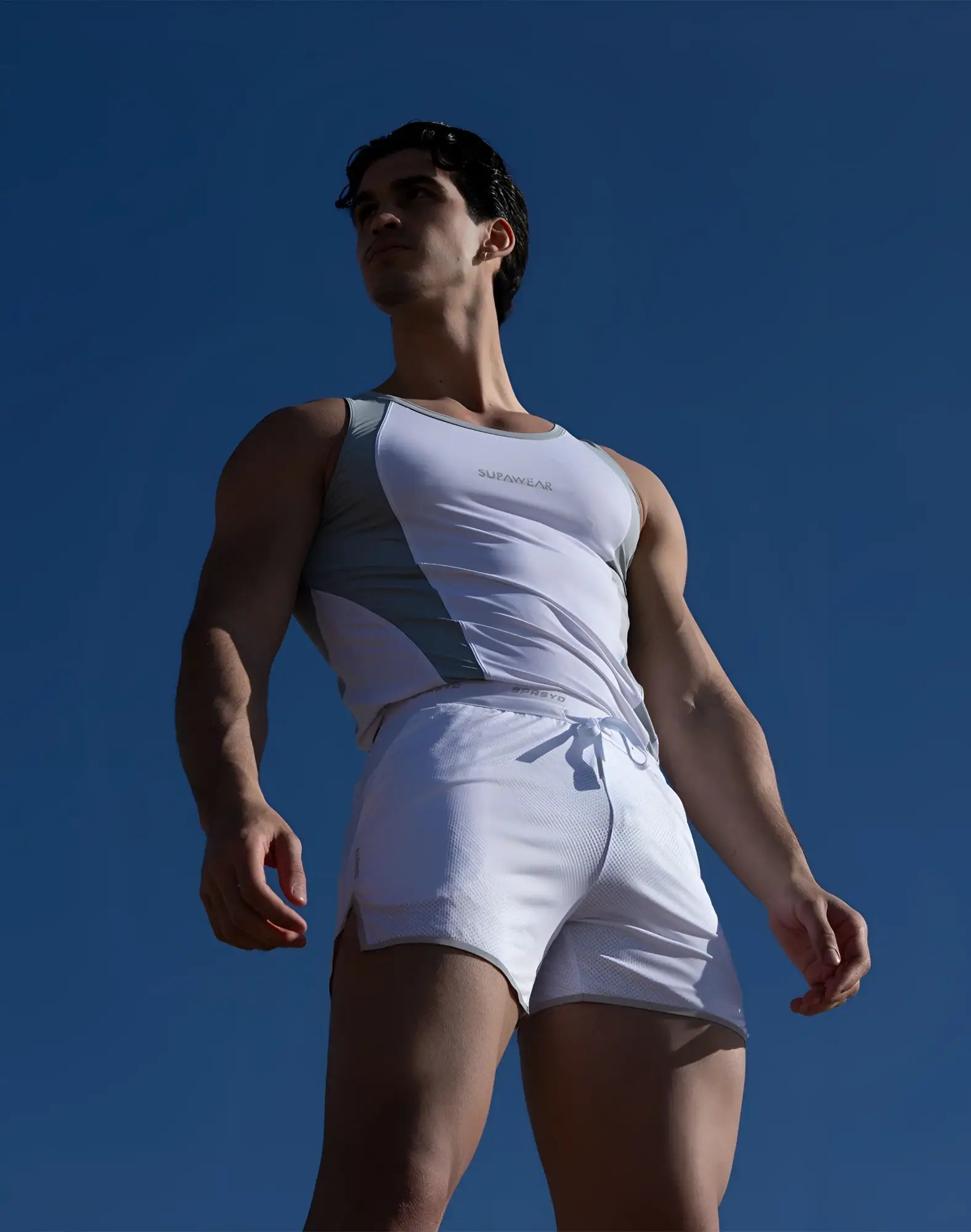 White and gray SUPAWEAR SPR Performance athletic tank top with subtle chest logo designed for active wear