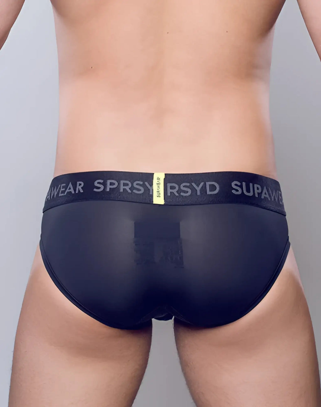 SupaWear SPR Pro brief underwear in black sheer fabric with branded elastic waistband and yellow tag visible