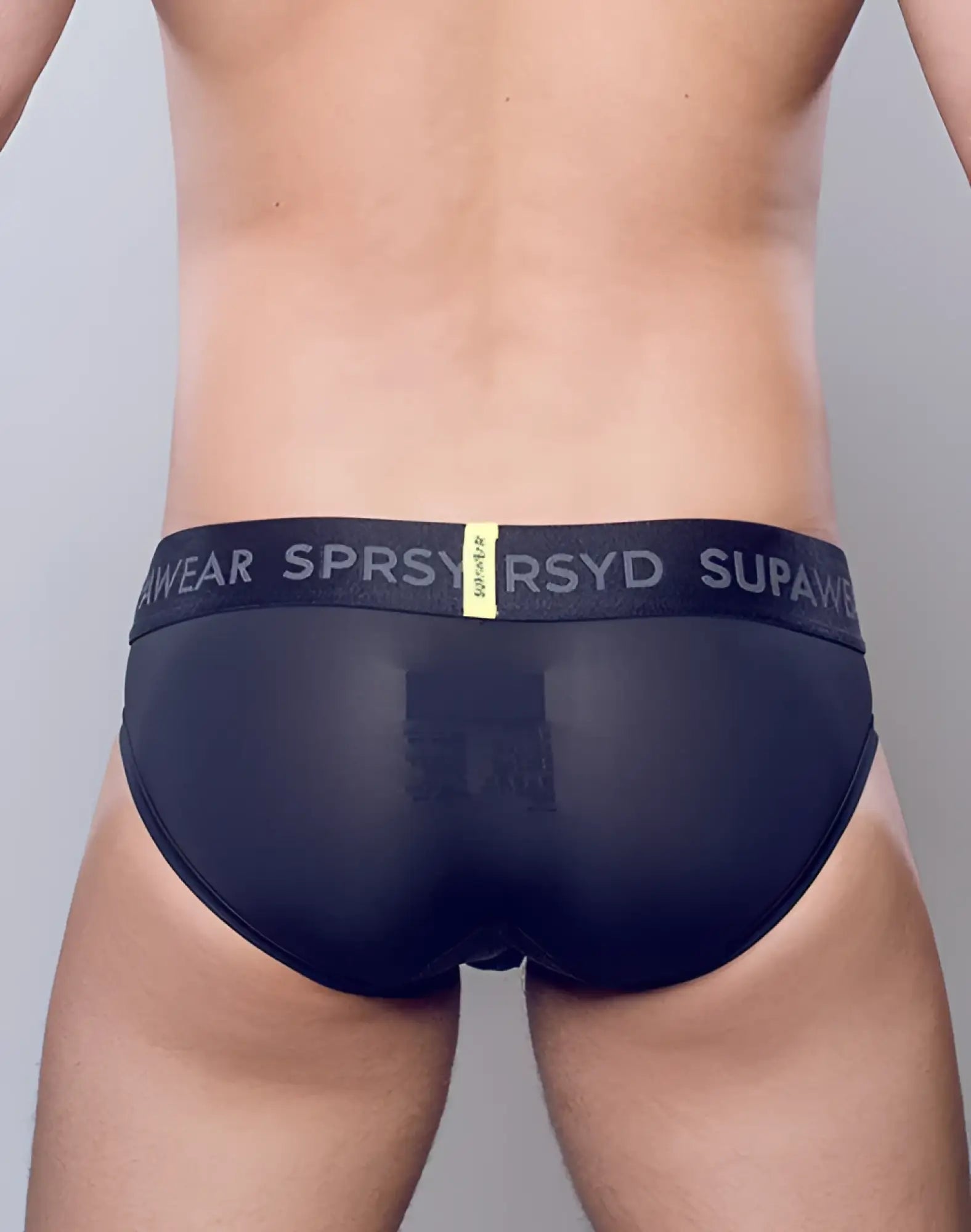SupaWear SPR Pro brief underwear in black sheer fabric with branded elastic waistband and yellow tag visible