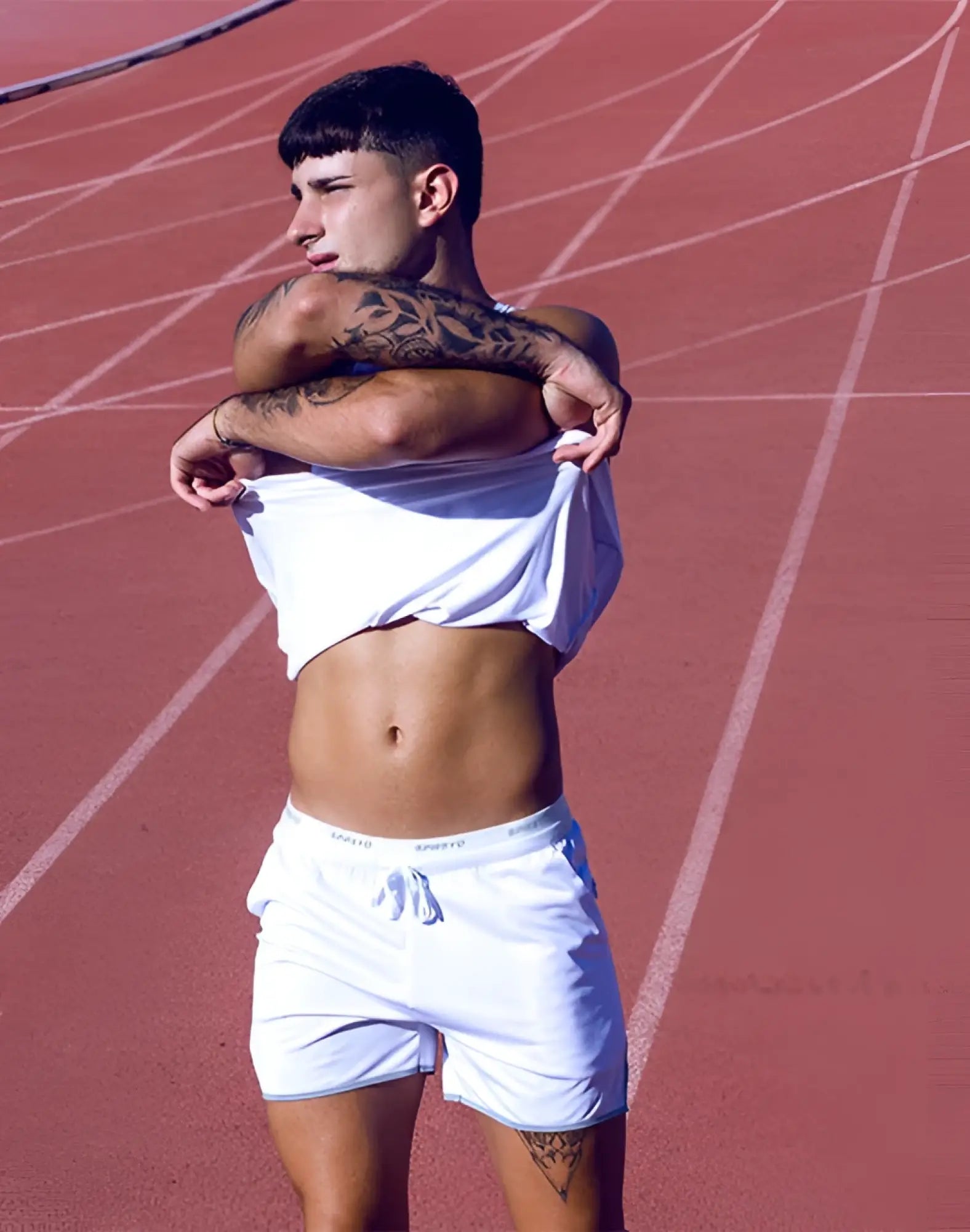 White supawear spr racer shorts with a drawstring waistband and subtle side branding for athletic use