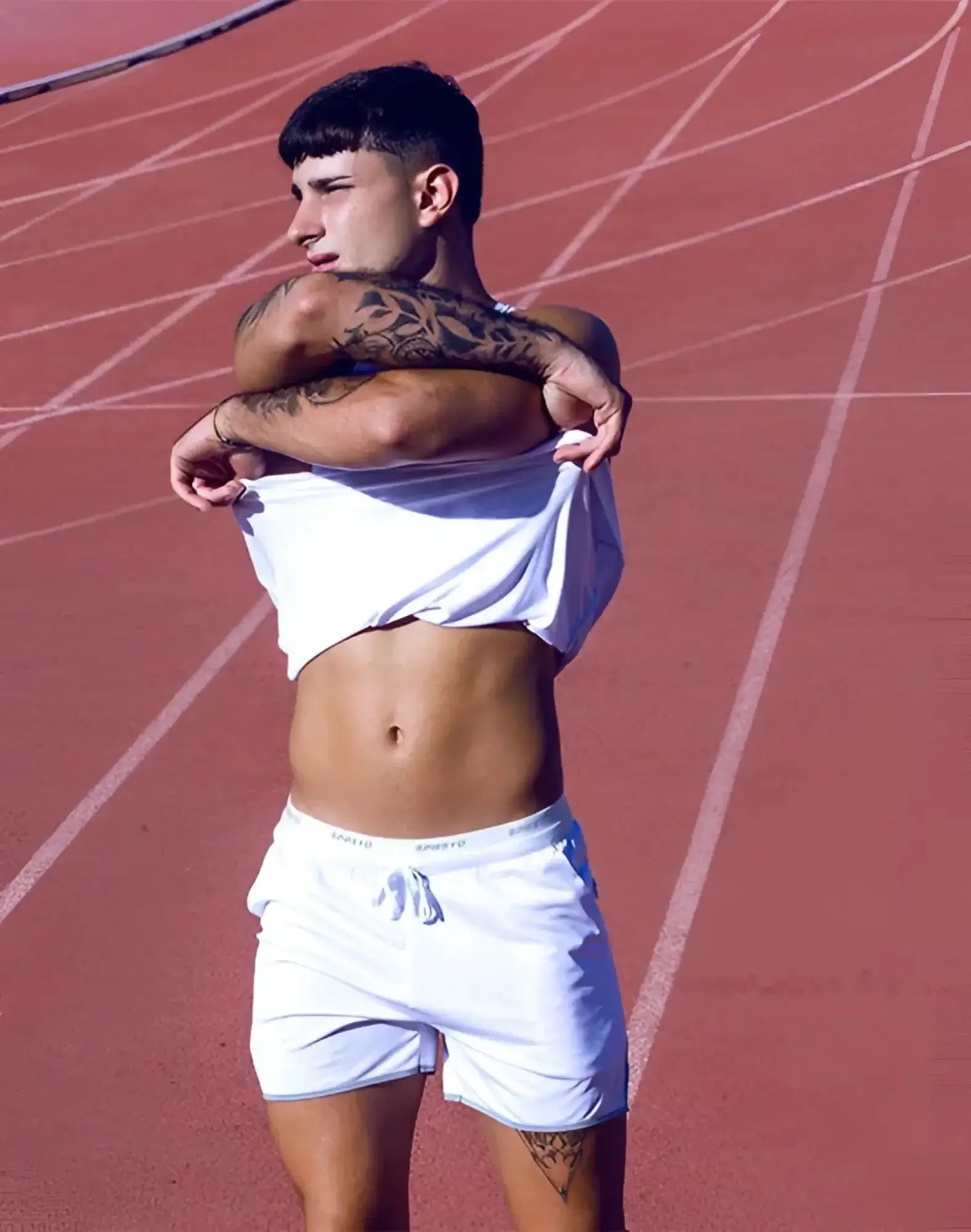 White supawear spr racer shorts with a drawstring waistband and subtle side branding for athletic use