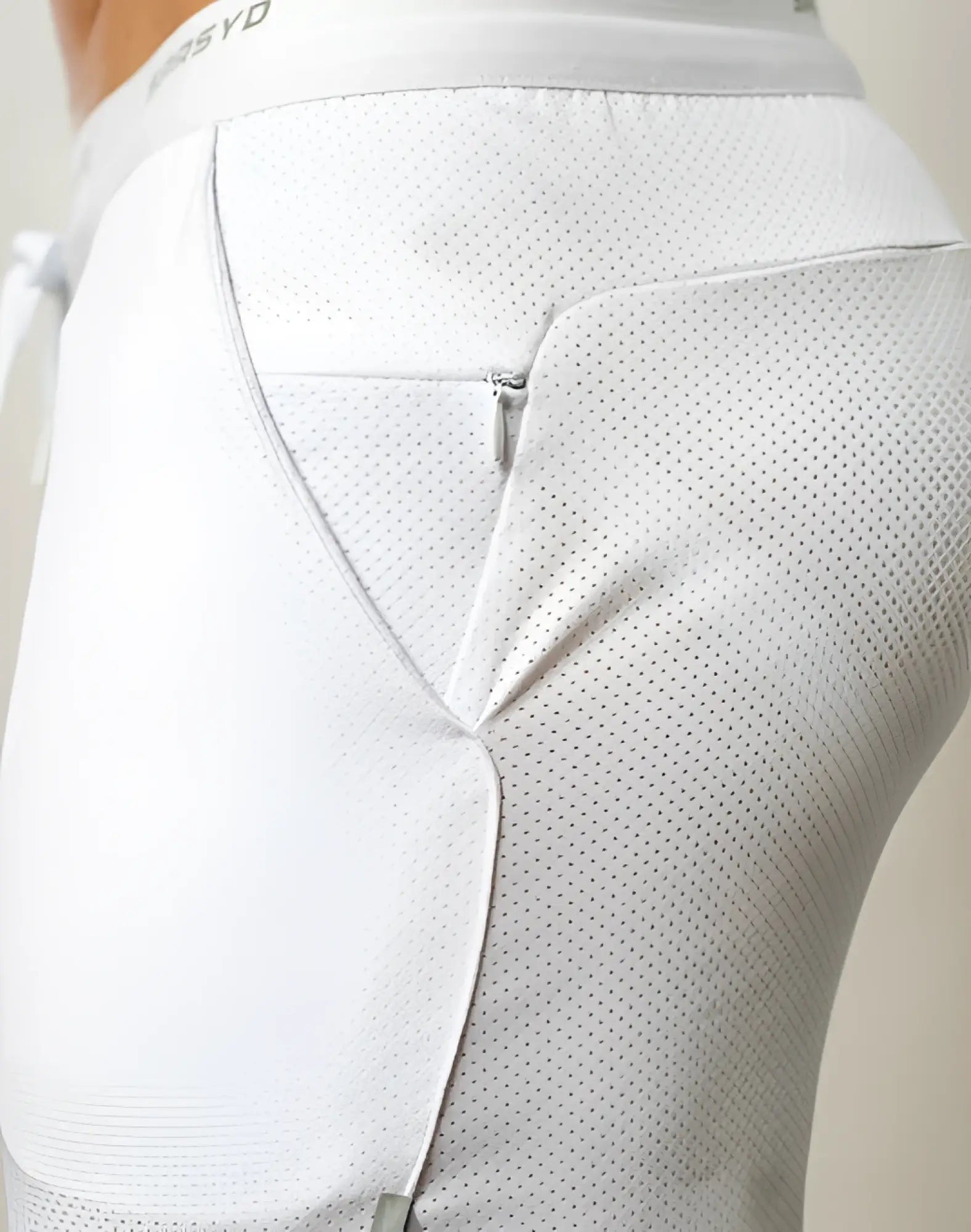 SupaWear SPR racer shorts in white with perforated mesh fabric and subtle waistband branding for athletic use