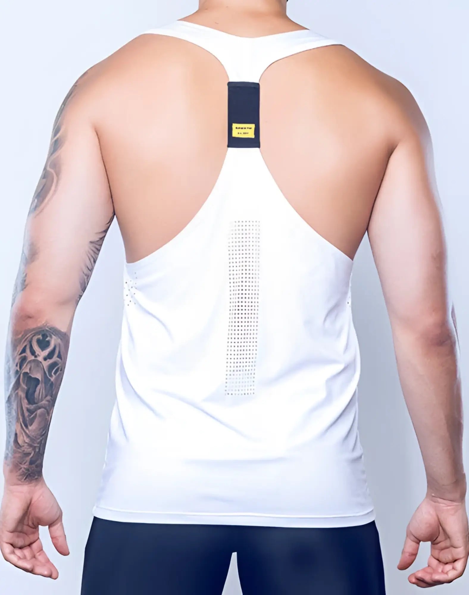 Back view of supawear spr y-tank white athletic tank top with black panel and vertical mesh design center back