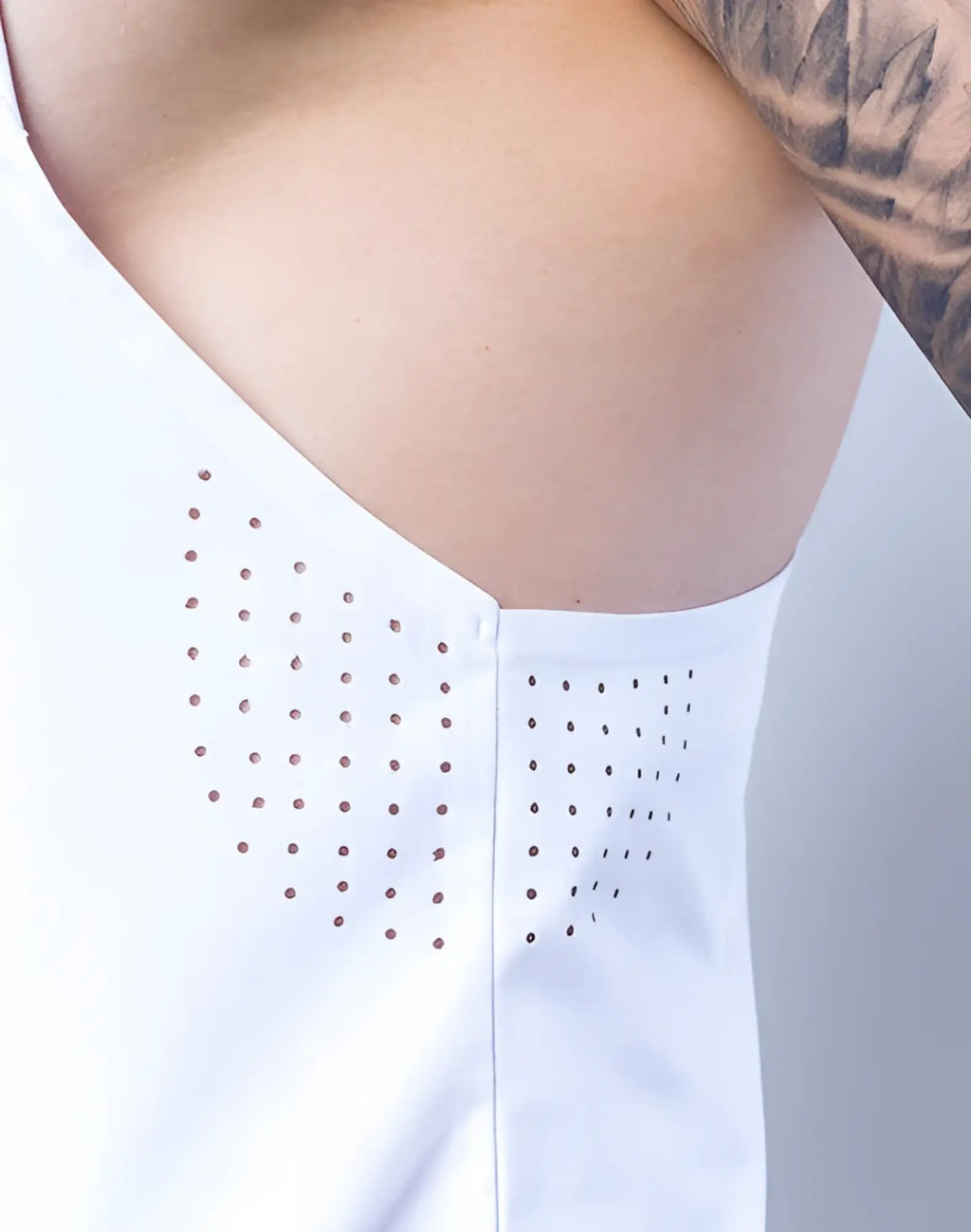 White sleeveless SUPAWEAR SPR Y-Tank with small perforations along shoulder and side seams for breathability