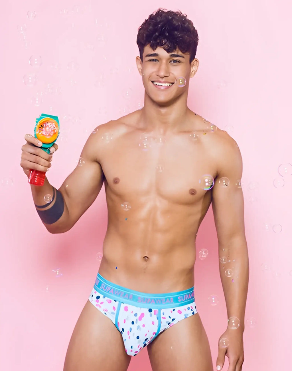 SupaWear Sprint brief underwear in white with colorful polka dots and a teal waistband for everyday comfort
