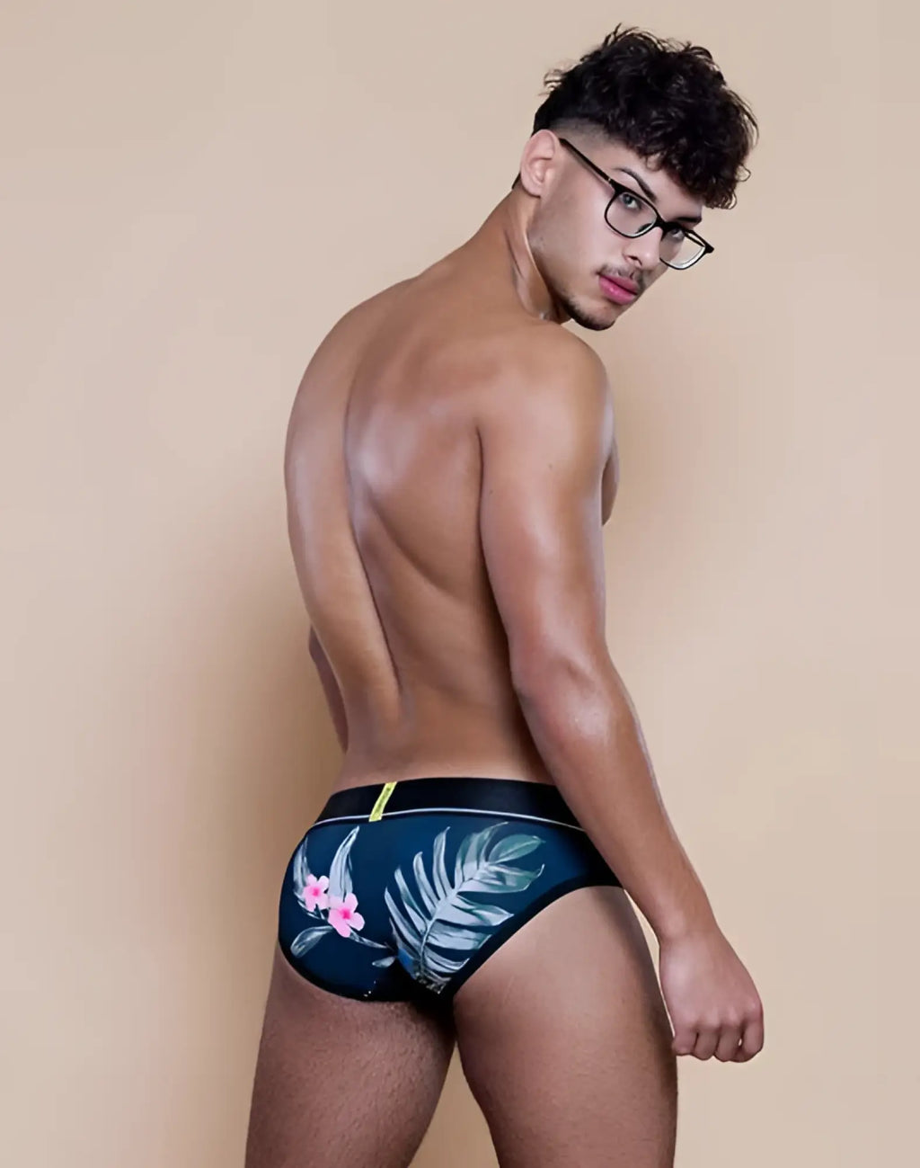 Dark blue supawear sprint brief underwear with tropical pink flowers white palm leaves and black waistband jamaica style