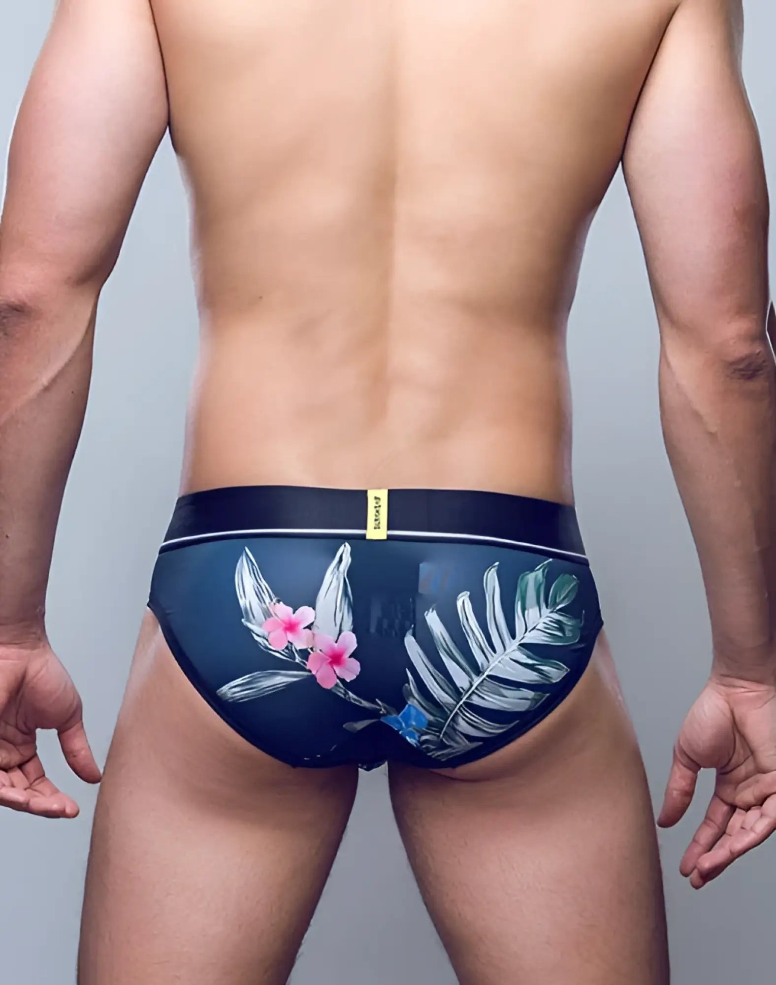 Supawee sprint brief underwear in dark blue with tropical pink flowers white green foliage and black waistband with yellow tag