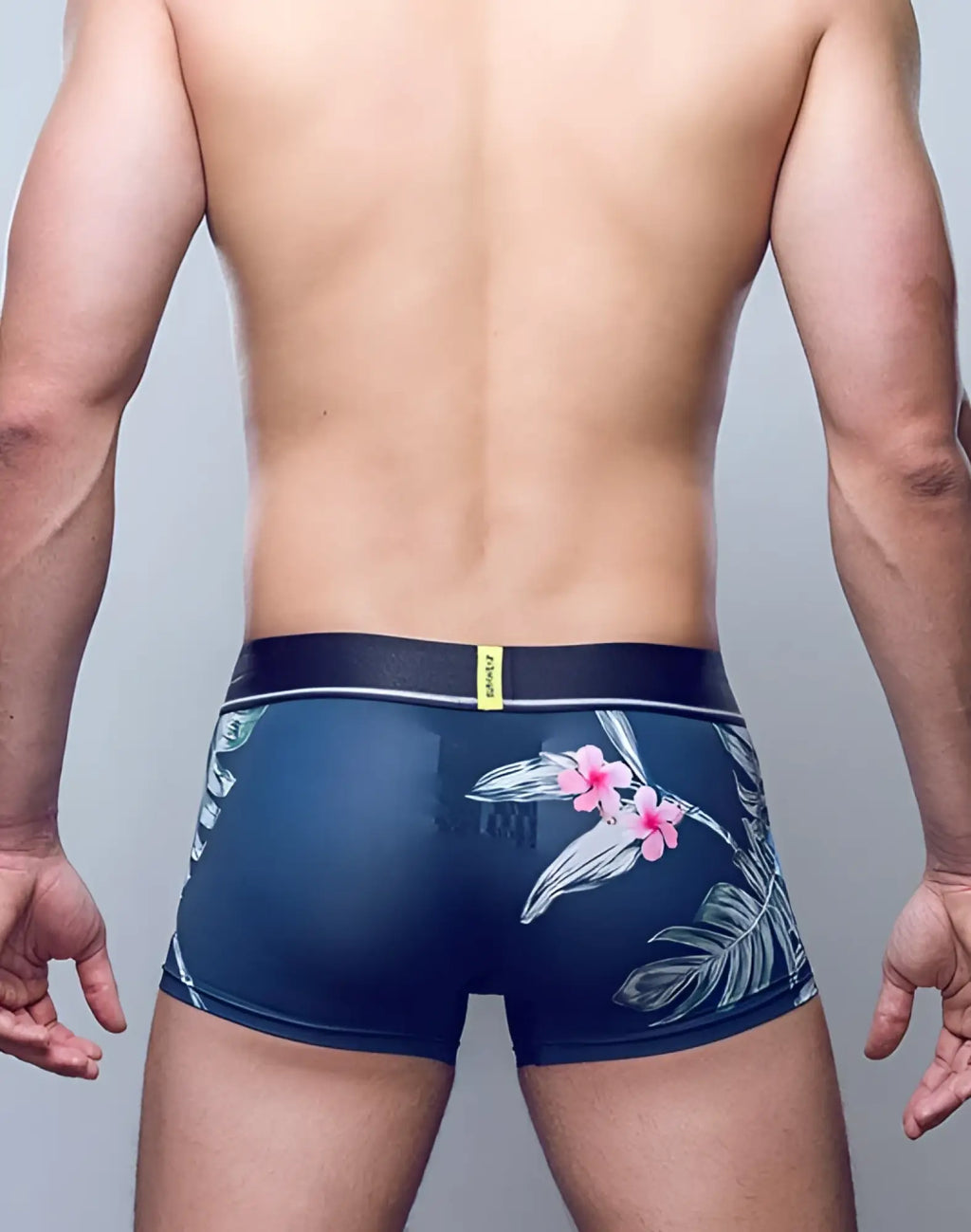 Navy blue SUPAWEAR Sprint trunk underwear with pink white floral side pattern and black waistband with yellow tag