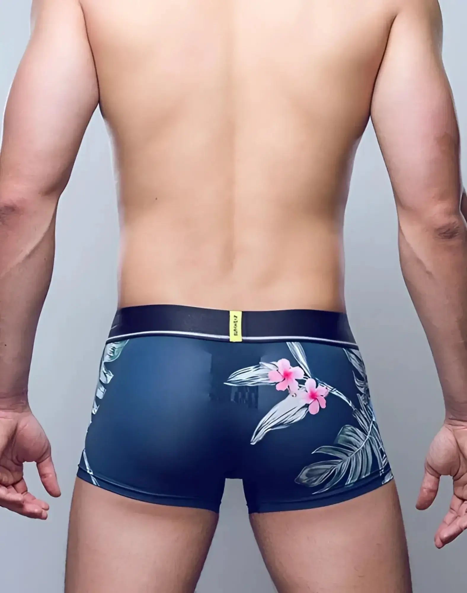 Navy blue SUPAWEAR Sprint trunk underwear with pink white floral side pattern and black waistband with yellow tag