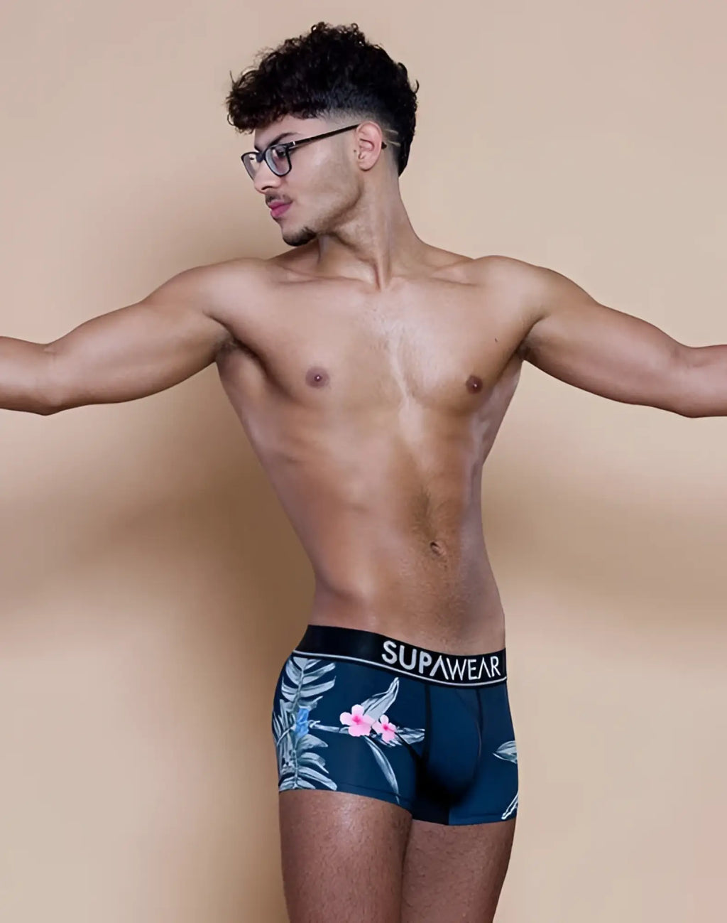 Navy blue supawear sprint trunk briefs with tropical pink flowers and light green leaves in jamaica print