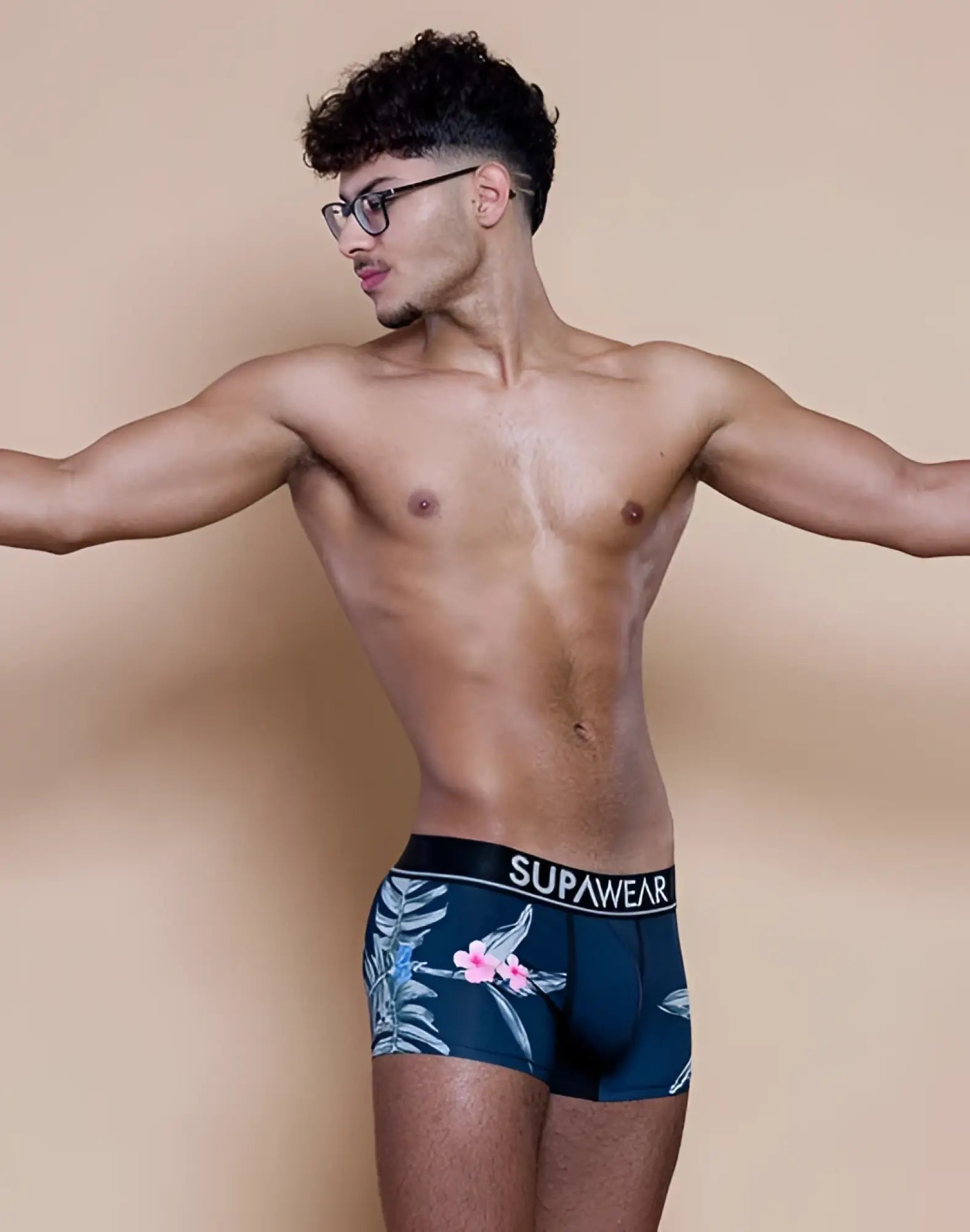 Navy blue supawear sprint trunk briefs with tropical pink flowers and light green leaves in jamaica print