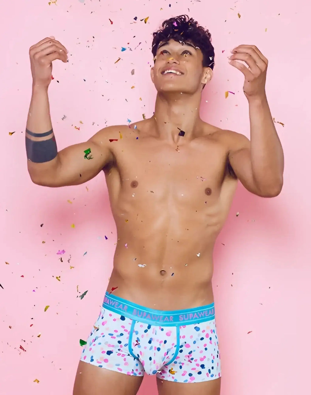 White boxer briefs with playful pink blue and black polka dots and turquoise supawear branded waistband