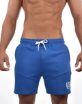 SupaWear storm shorts in blue with a white drawstring and small embroidered logo on the lower right leg