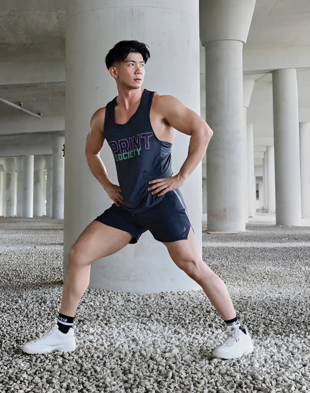 Dark gray sleeveless athletic tank top with multicolored print society lettering across the chest