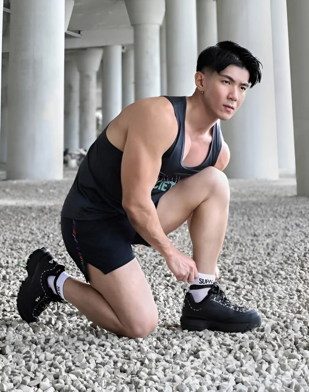 Black supra sneakers with chunky soles and laces paired with supawear supa white ankle socks featuring the logo