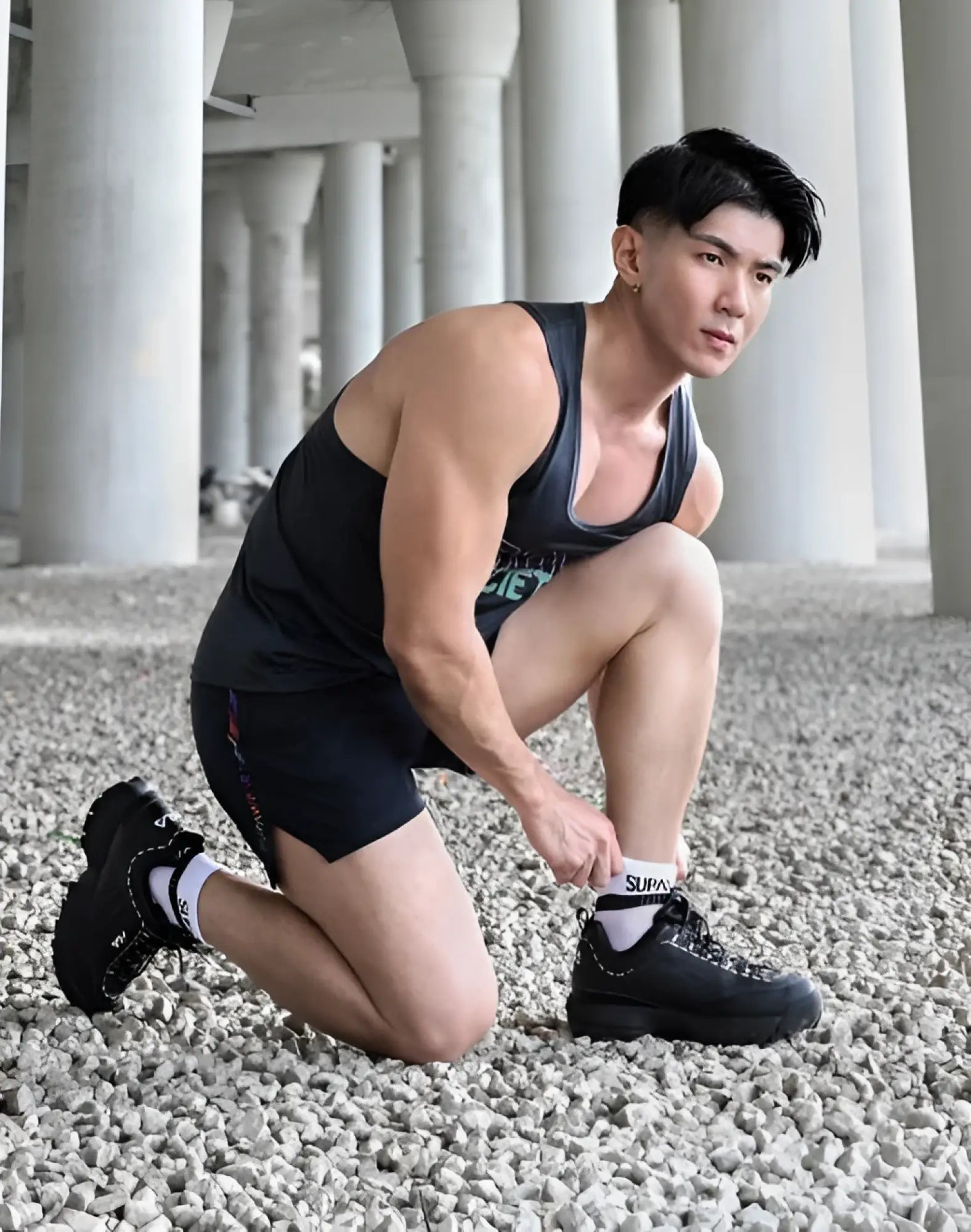 Black supra sneakers with chunky soles and laces paired with supawear supa white ankle socks featuring the logo