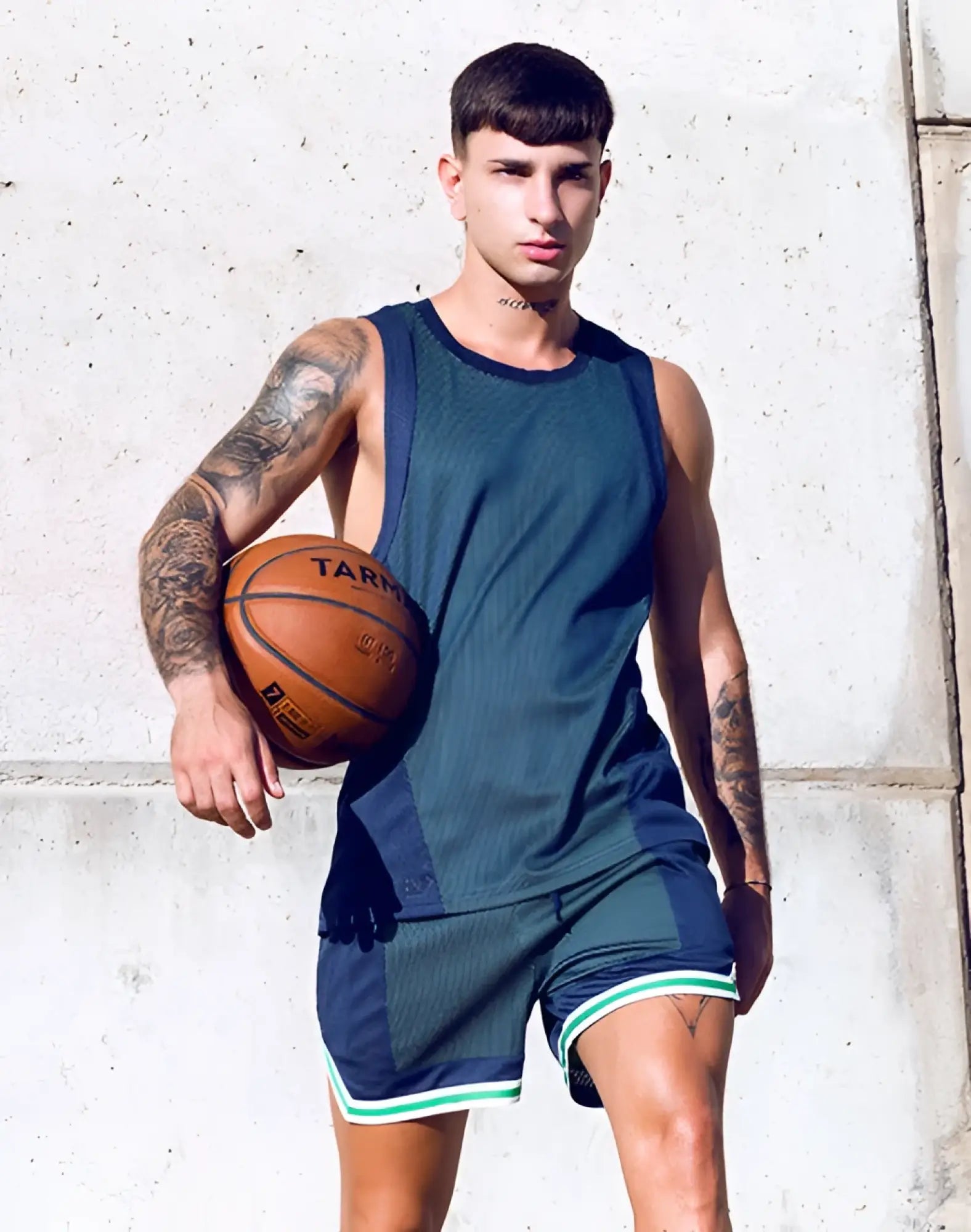 Orange basketball with black lettering and seams shown alongside supawear swish mesh singlet in neon green