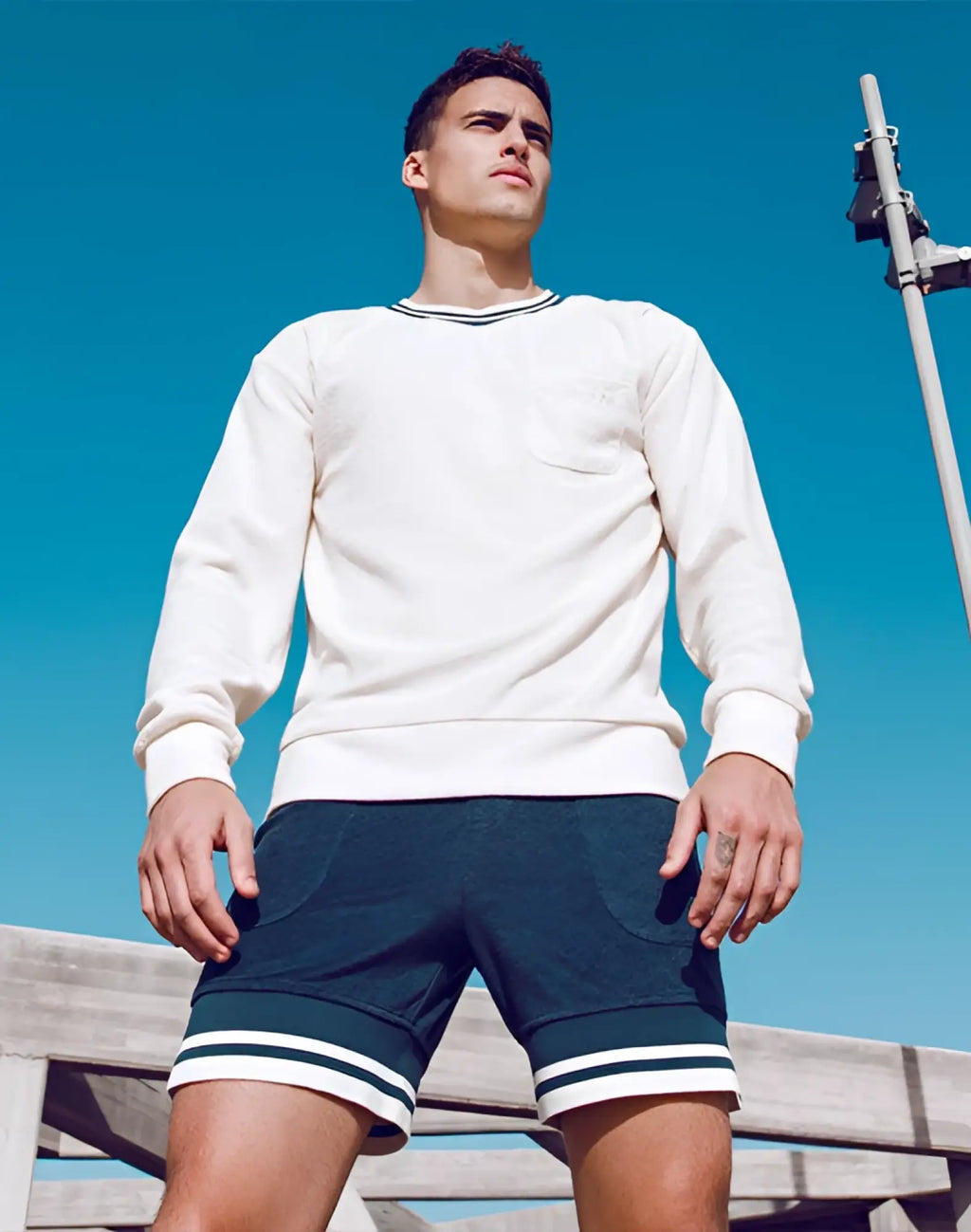 Cream-colored SUPAWEAR terry towelling long-sleeved sweater with navy blue and white striped trim at neckline cuffs and hem