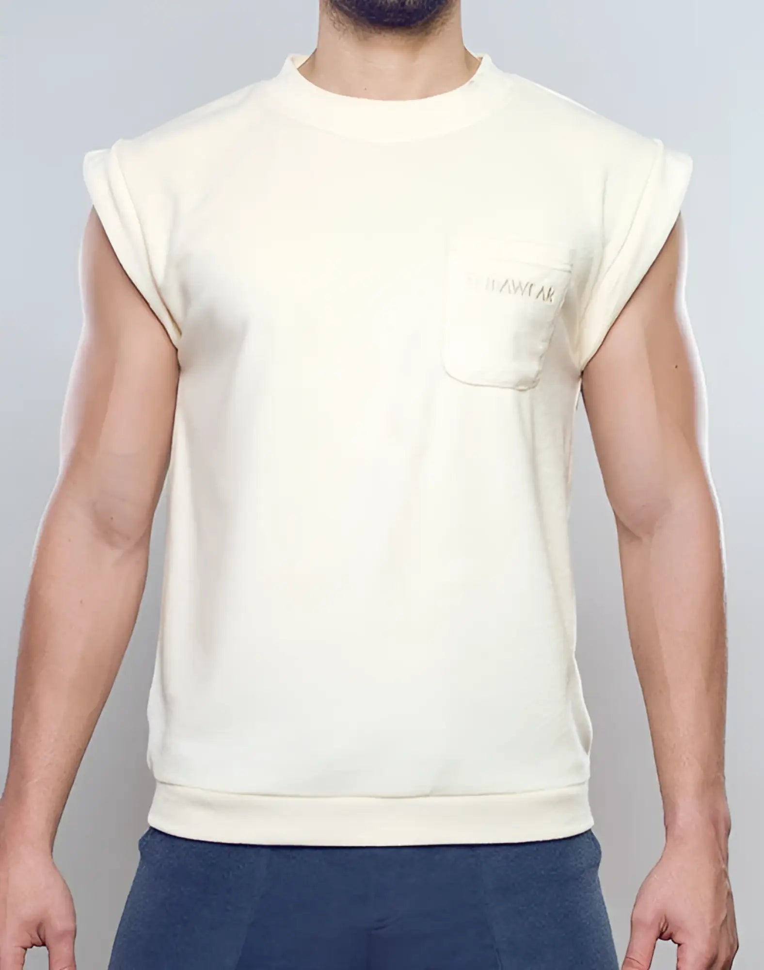 Cream-colored sleeveless SUPAWEAR terry towelling tank with ribbed crew neck and embroidered dreamwear chest pocket