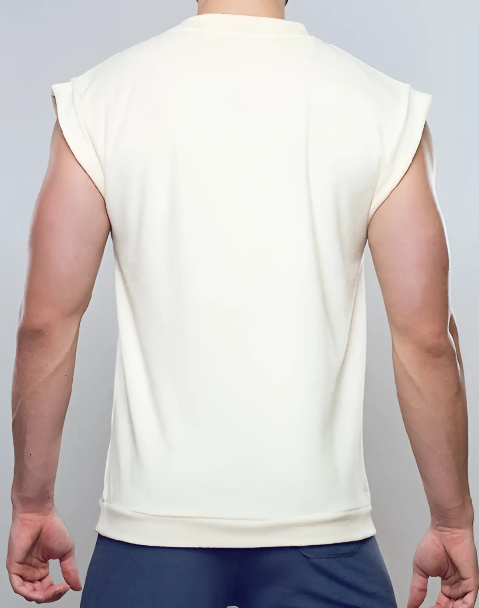 Cream-colored sleeveless sweatshirt terry towelling tank with soft textured fabric and ribbed cuffs by SUPAWEAR off white