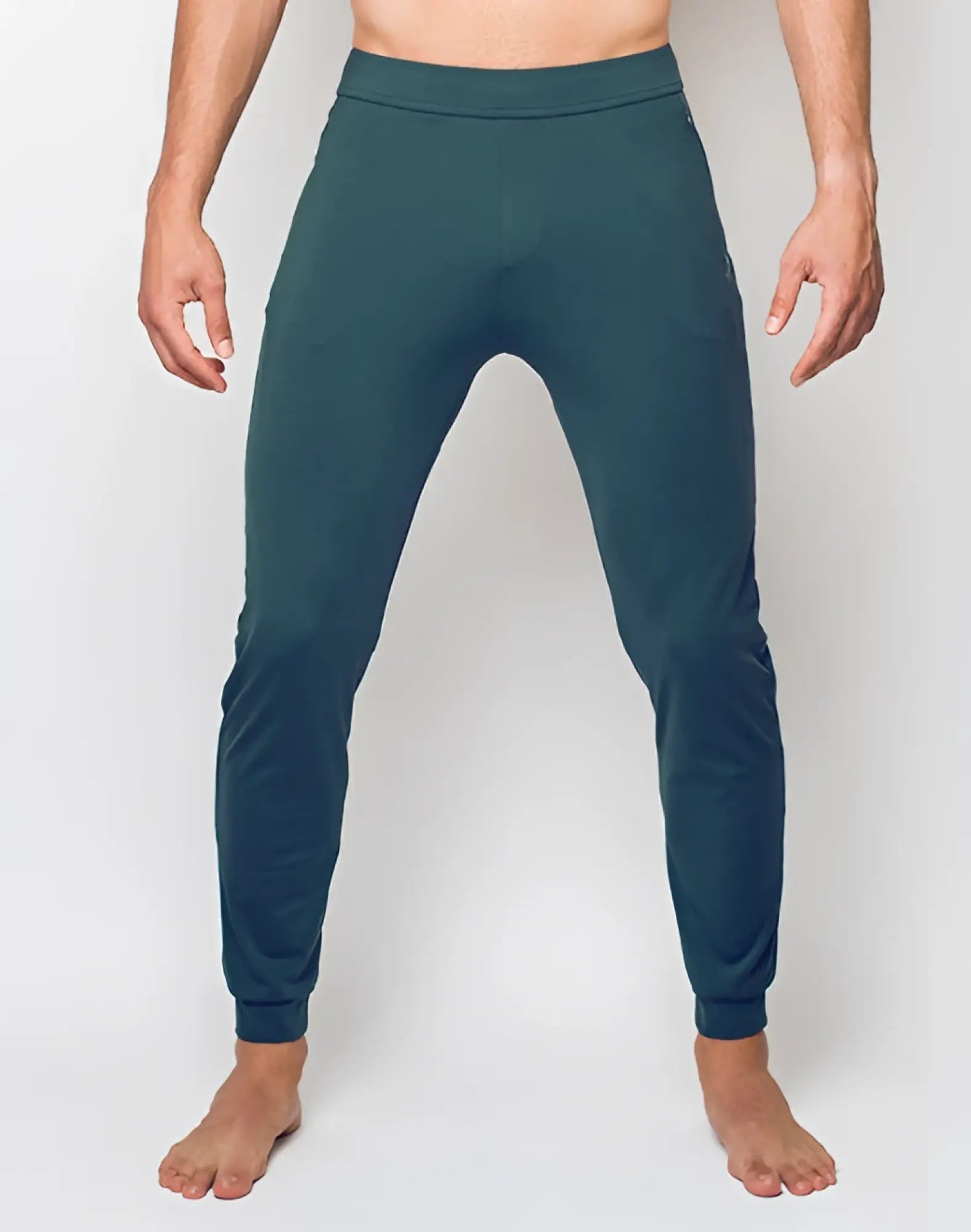 SupaWear training pants in nexus dark green with dark teal fabric, ribbed waistband, and elastic cuffs in form-fitting style
