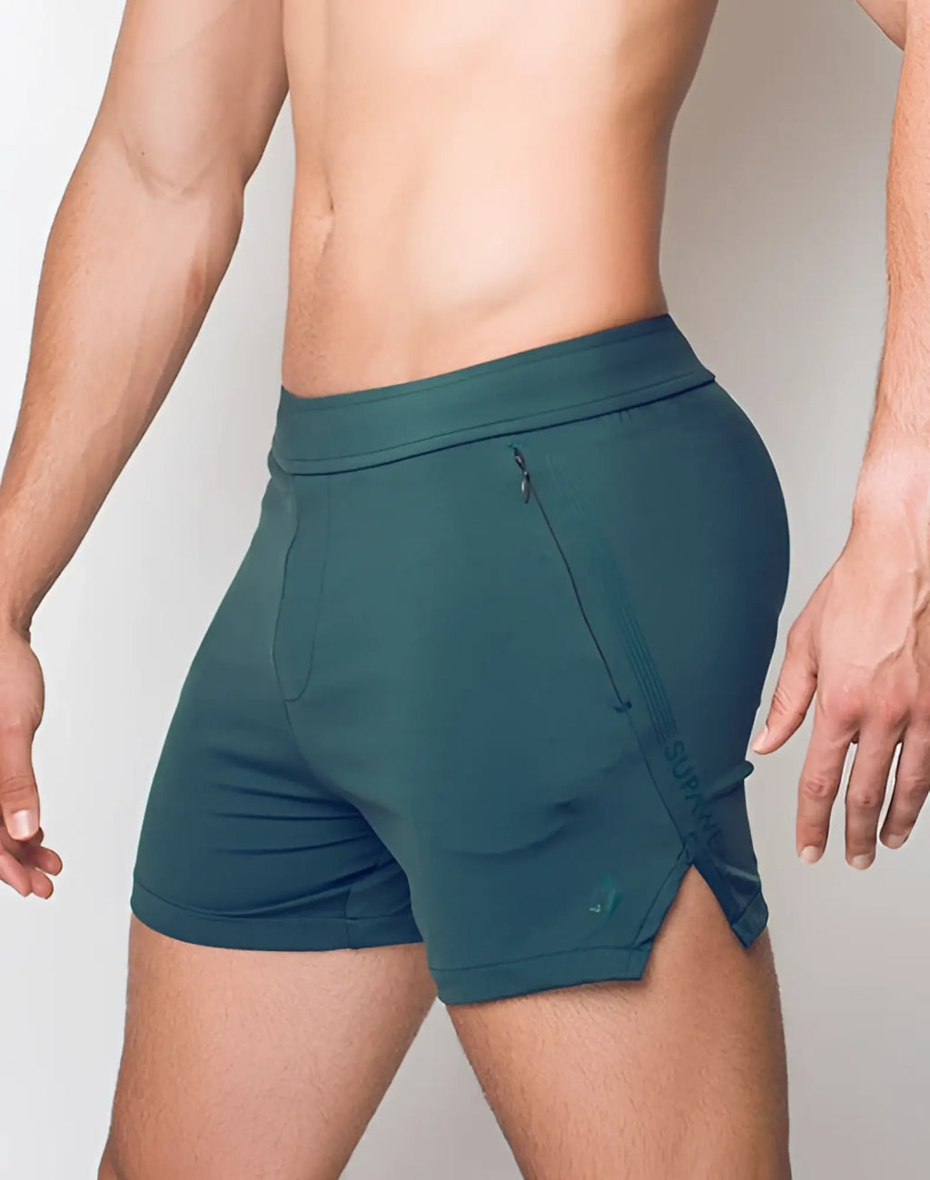 SupaWear training shorts in dark green with a zipper pocket and subtle side branding for athletic use