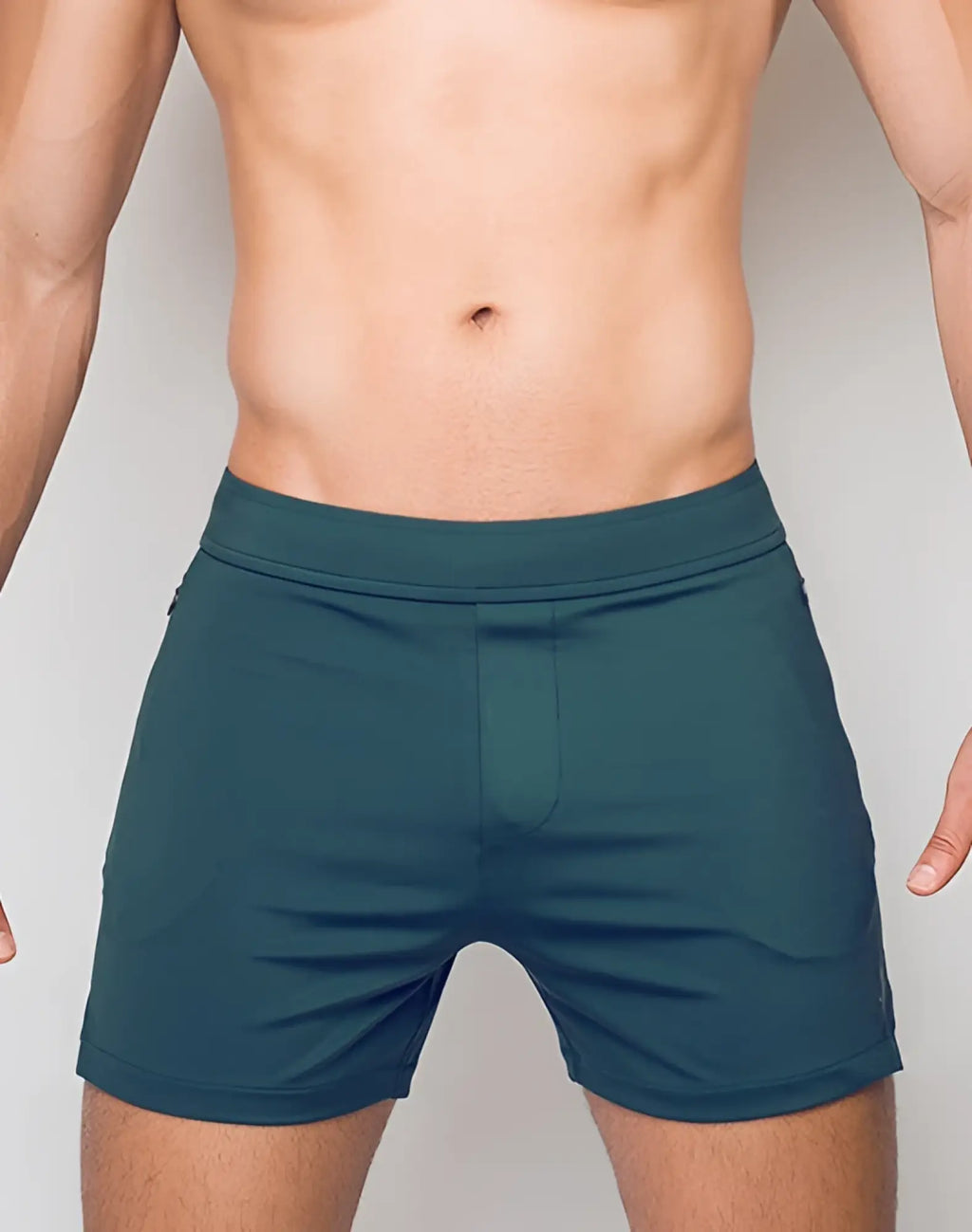 SupaWear training shorts in dark green feature a fitted waistband and minimalist design for athletic use
