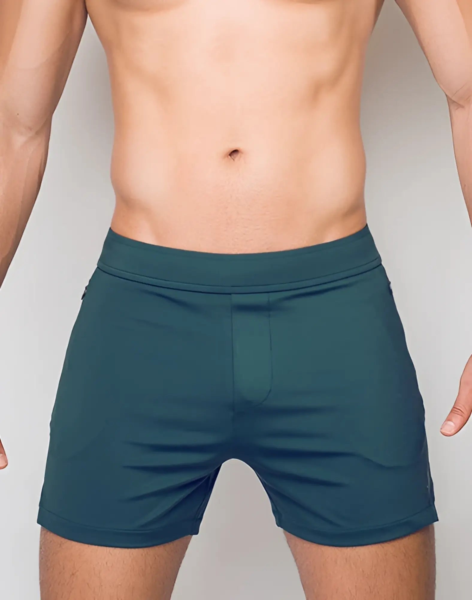 SupaWear training shorts in dark green feature a fitted waistband and minimalist design for athletic use