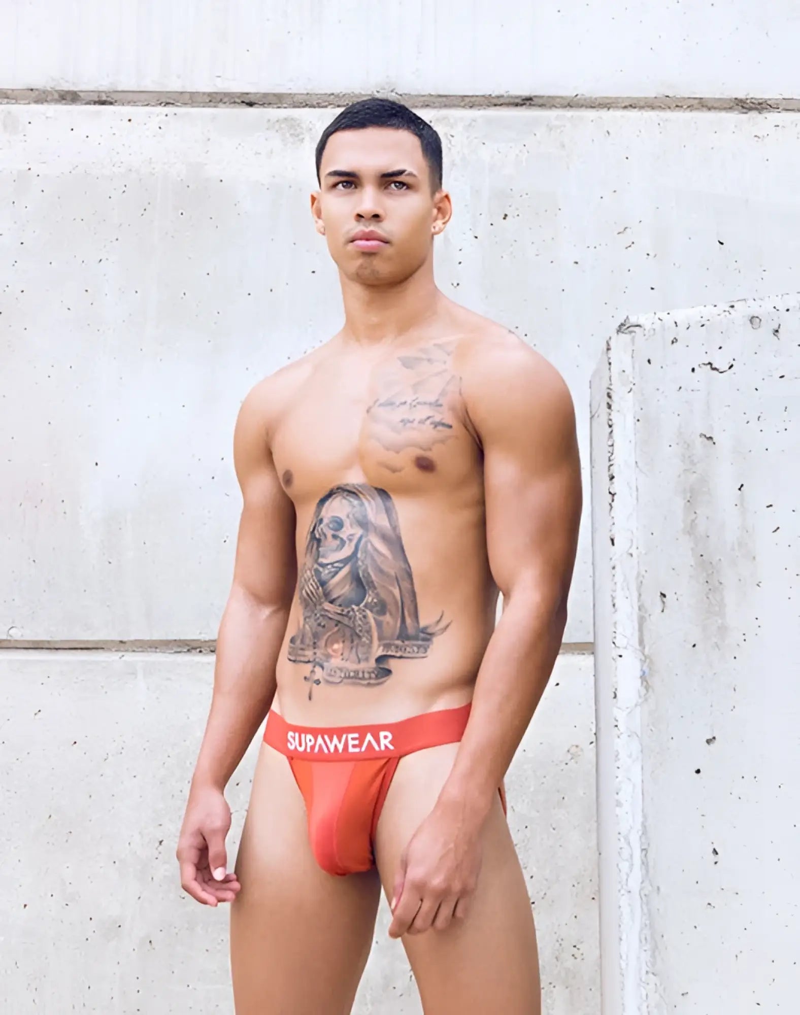 Orange supawear briefs with red waistband and white supawear branding in vortex jockstrap cranberry style