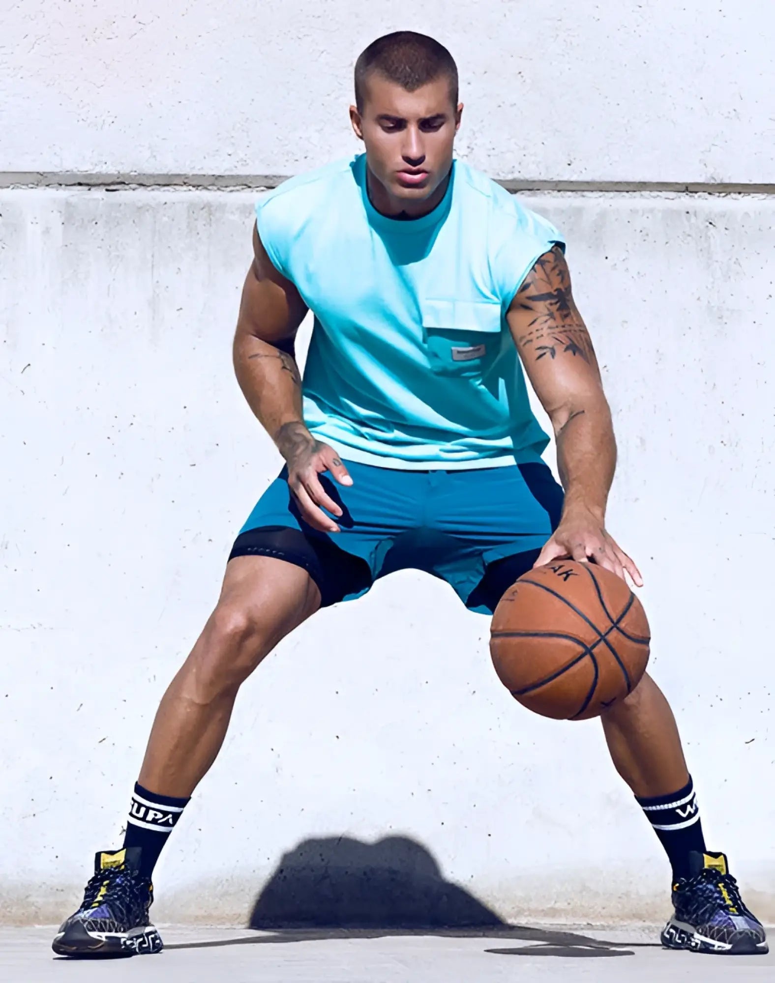 Classic orange basketball with black stitched seams featured alongside supawear wide-cut tank in turquoise blue