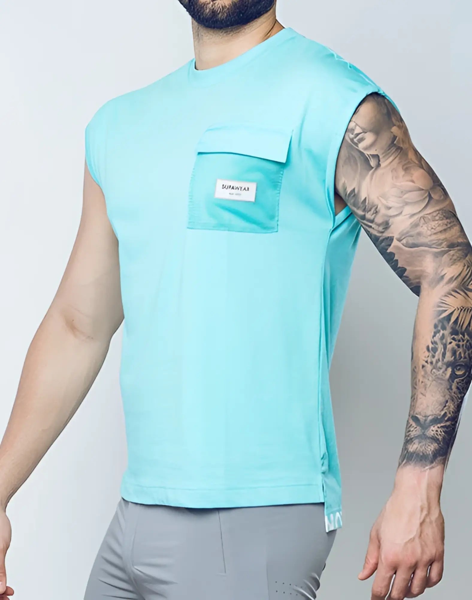 Light blue supawear wide-cut sleeveless tank with mesh pocket and white brand label for athletic use