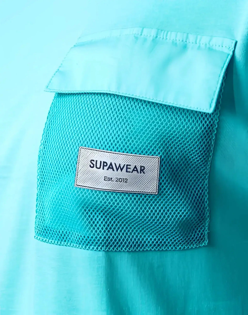 A turquoise blue supawear wide cut tank with a white mesh pocket and supawear label