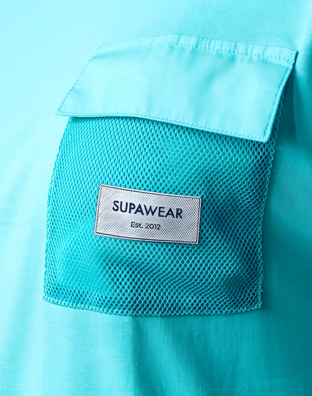 A turquoise blue supawear wide cut tank with a white mesh pocket and supawear label