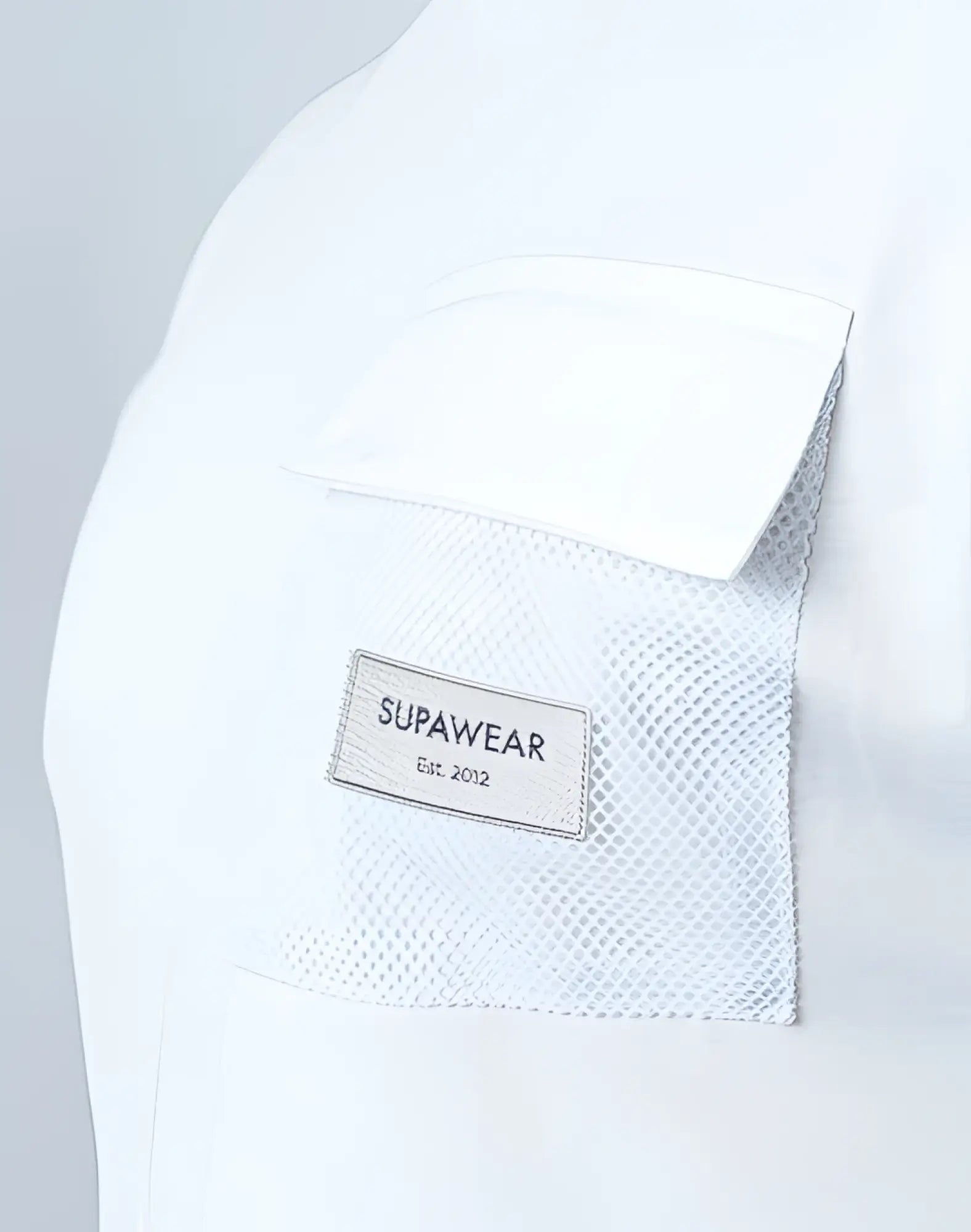 White supawear wide-cut tank back mesh pocket with rectangular supawear label stitched on it