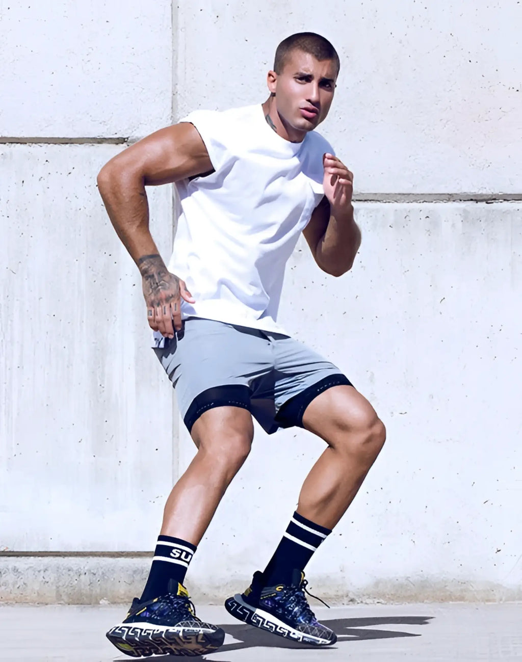 Navy blue and yellow patterned athletic sneakers with geometric design paired with supawear wide cut tank white