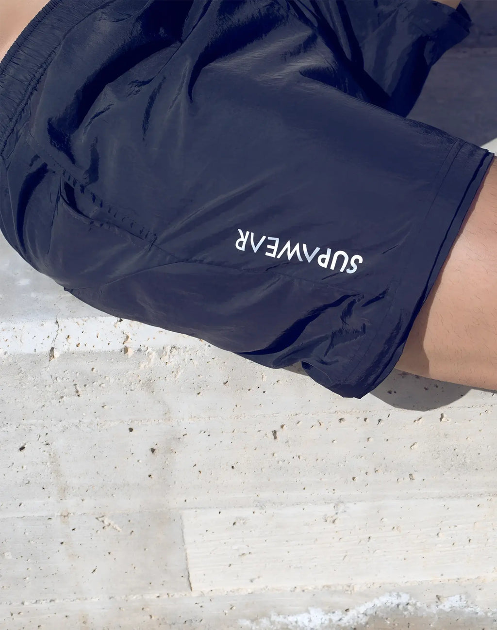 Dark navy blue supawear zip off trouser with white logo embroidered on the side seam for athletic use