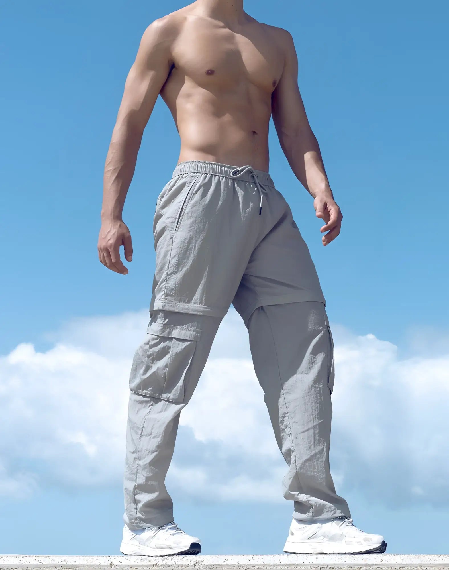 Light gray SUPAWEAR zip-off trouser cargo pants with multiple pockets and a drawstring waistband for versatile wear